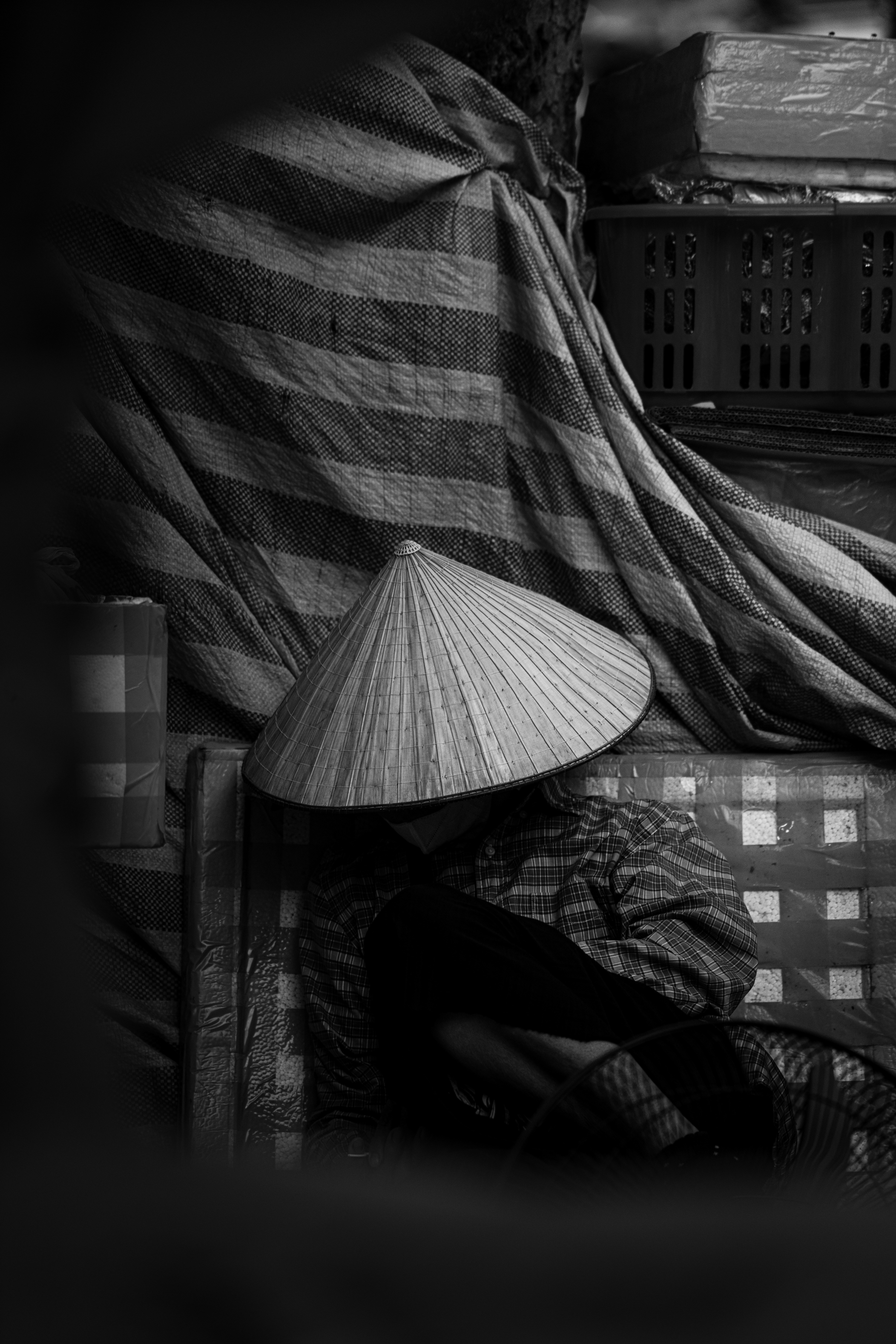 A black and white photo of a person sitting on a couch