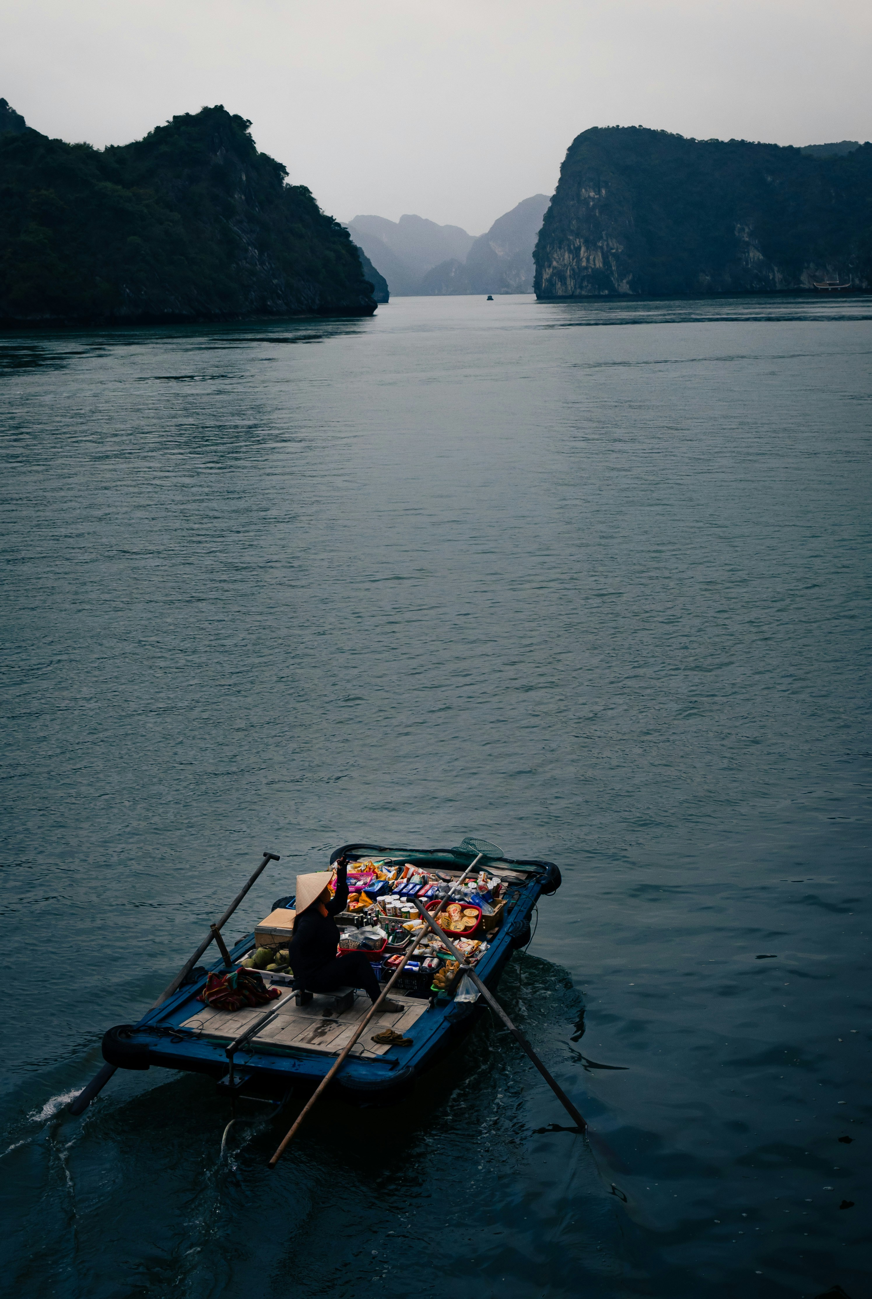 A small boat floating on top of a large body of water