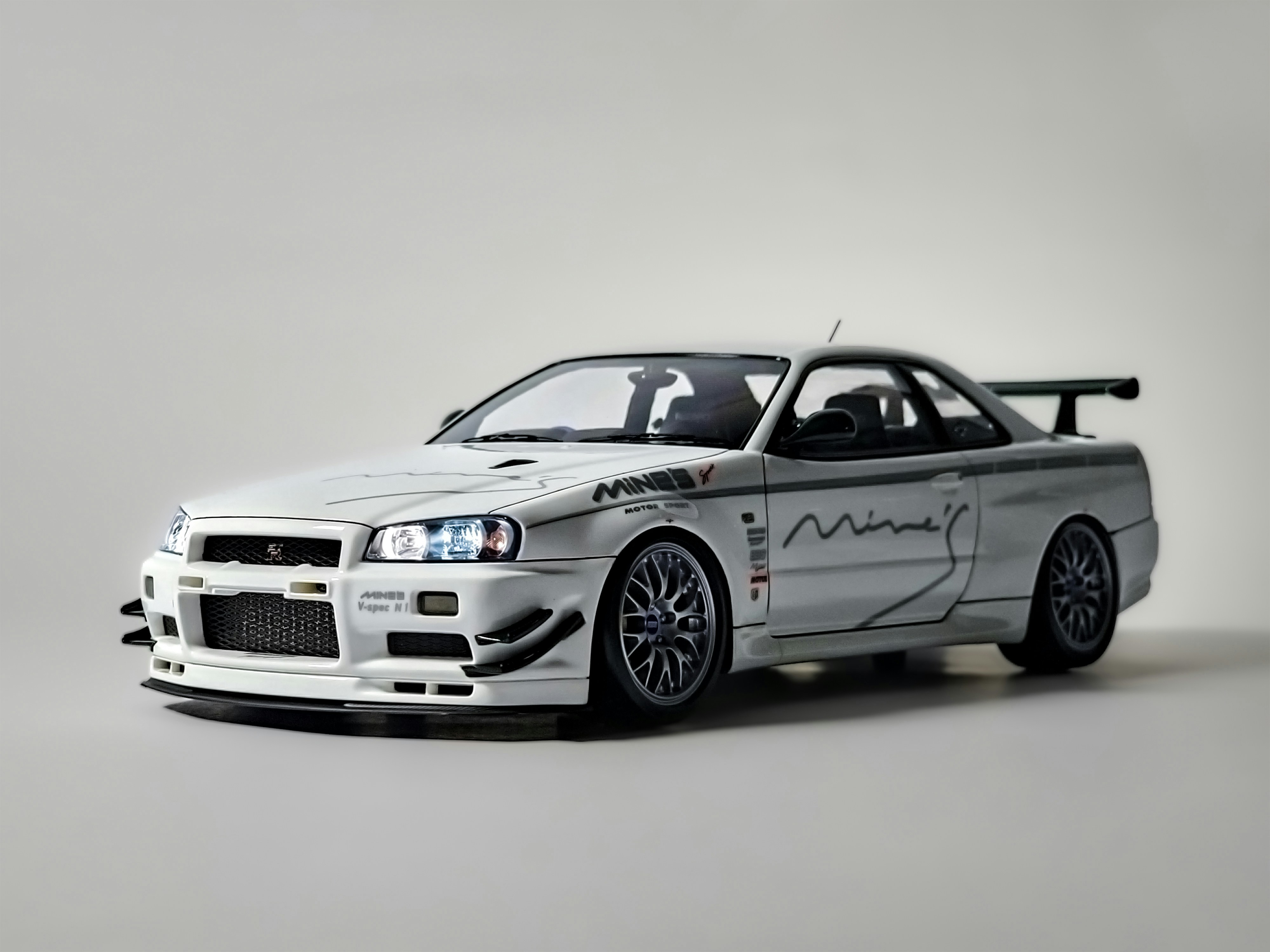 A white car with a racing theme painted on it