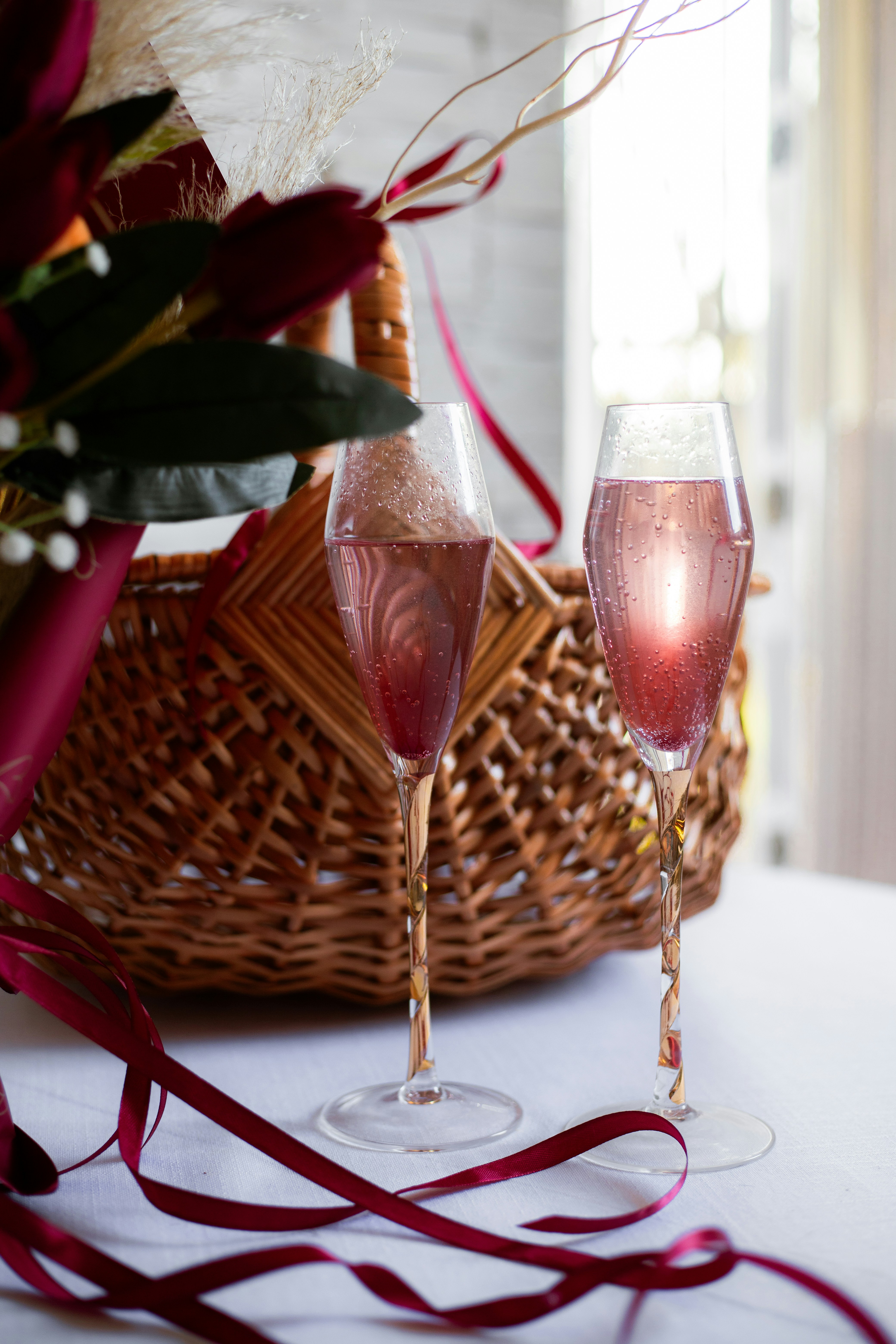 Two glasses of wine are sitting on a table