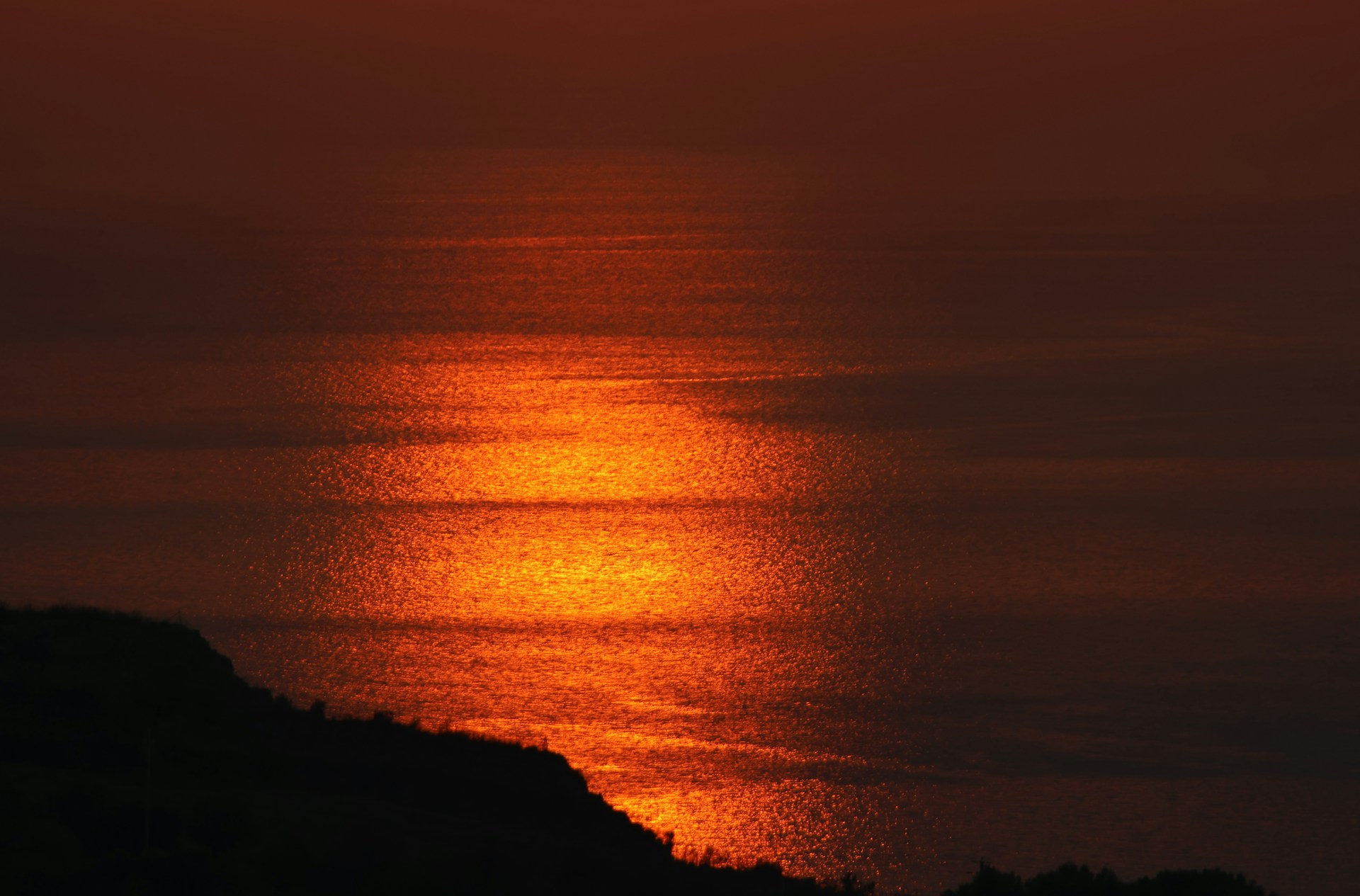 The sun is setting over a body of water