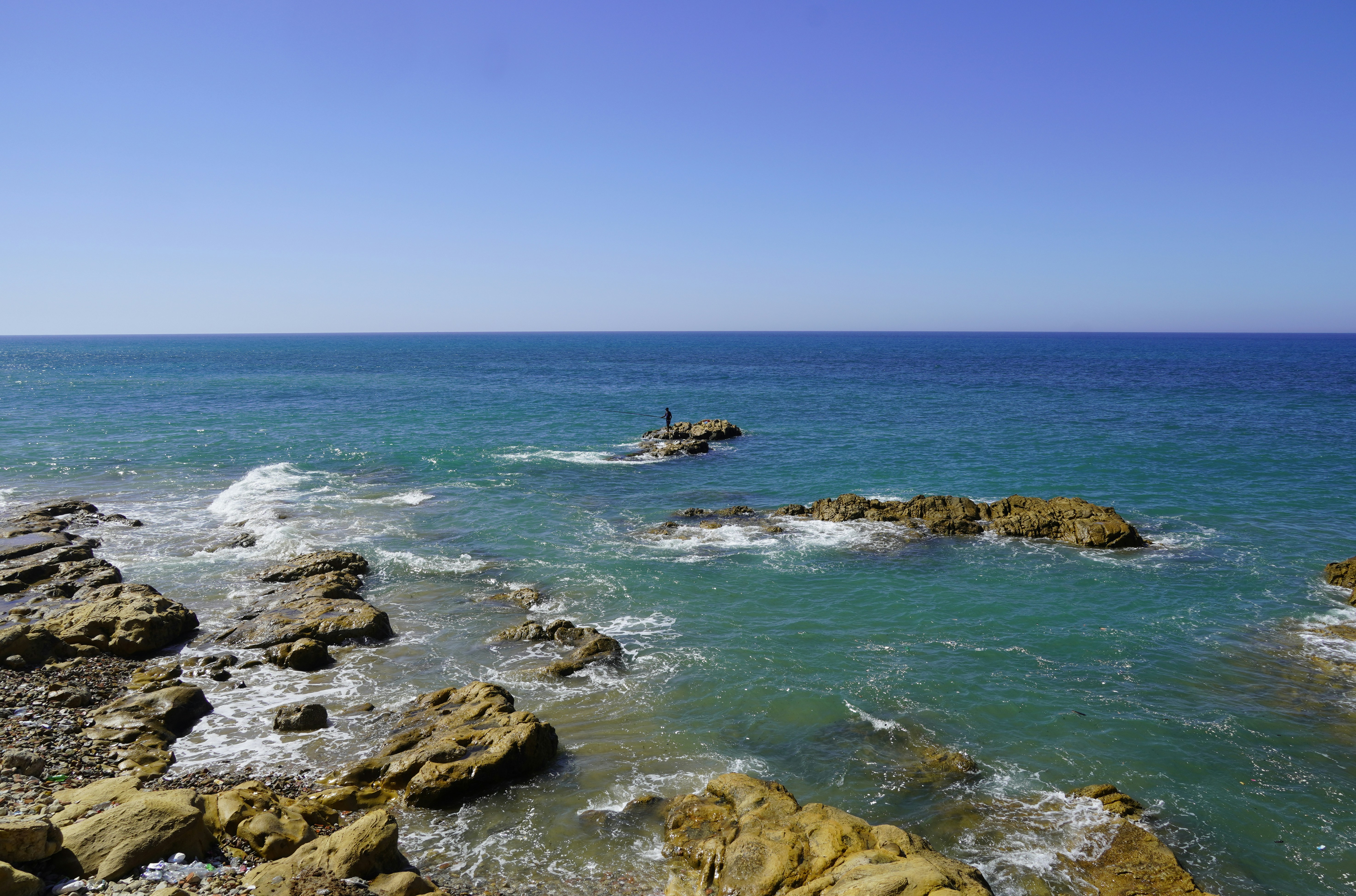 A view of the ocean from a rocky shore