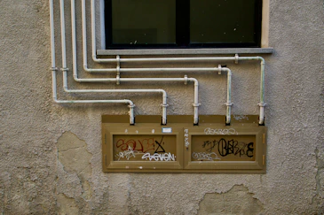 A wall with a bunch of pipes attached to it