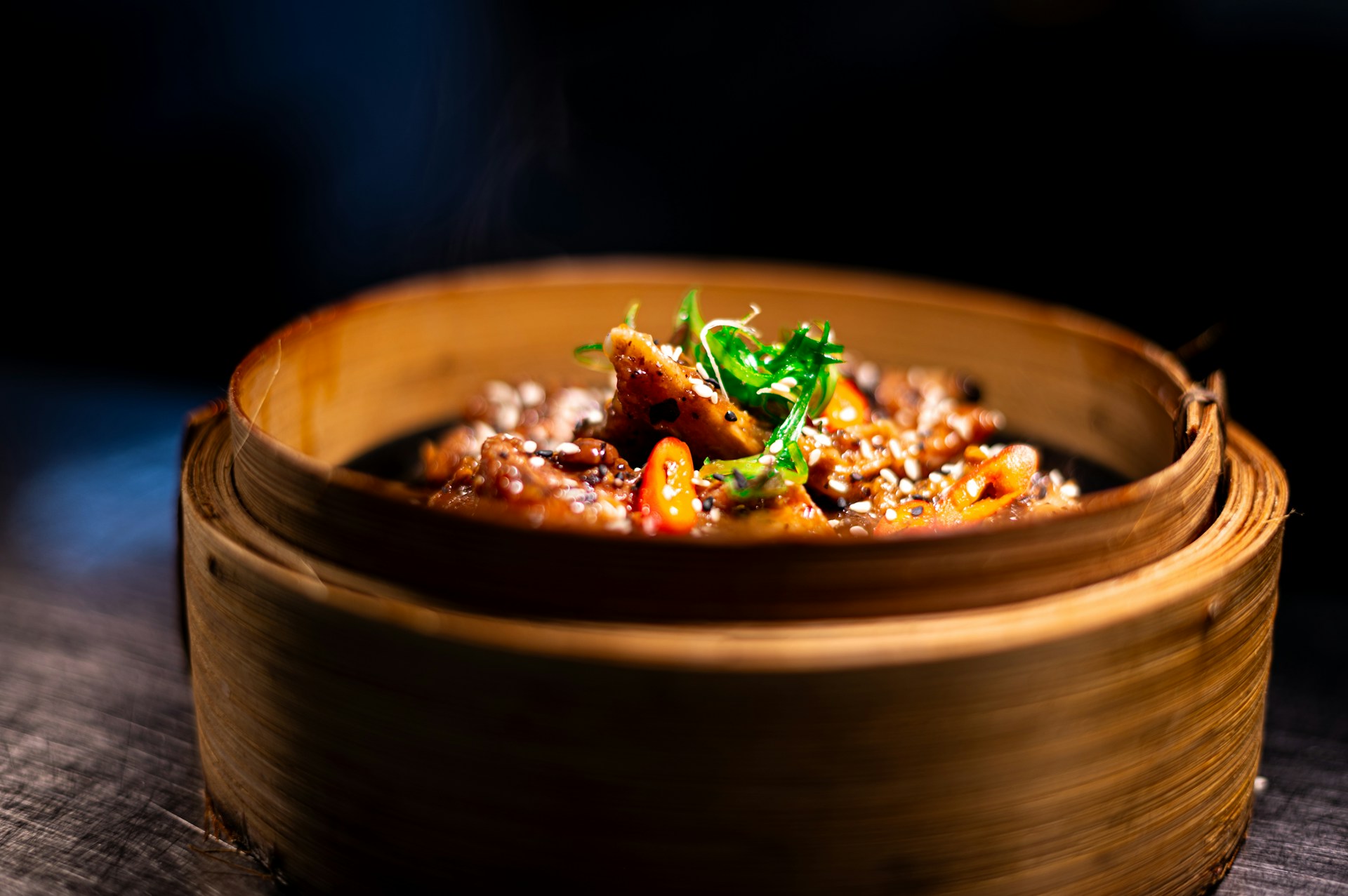 A wooden bowl filled with food on top of a table