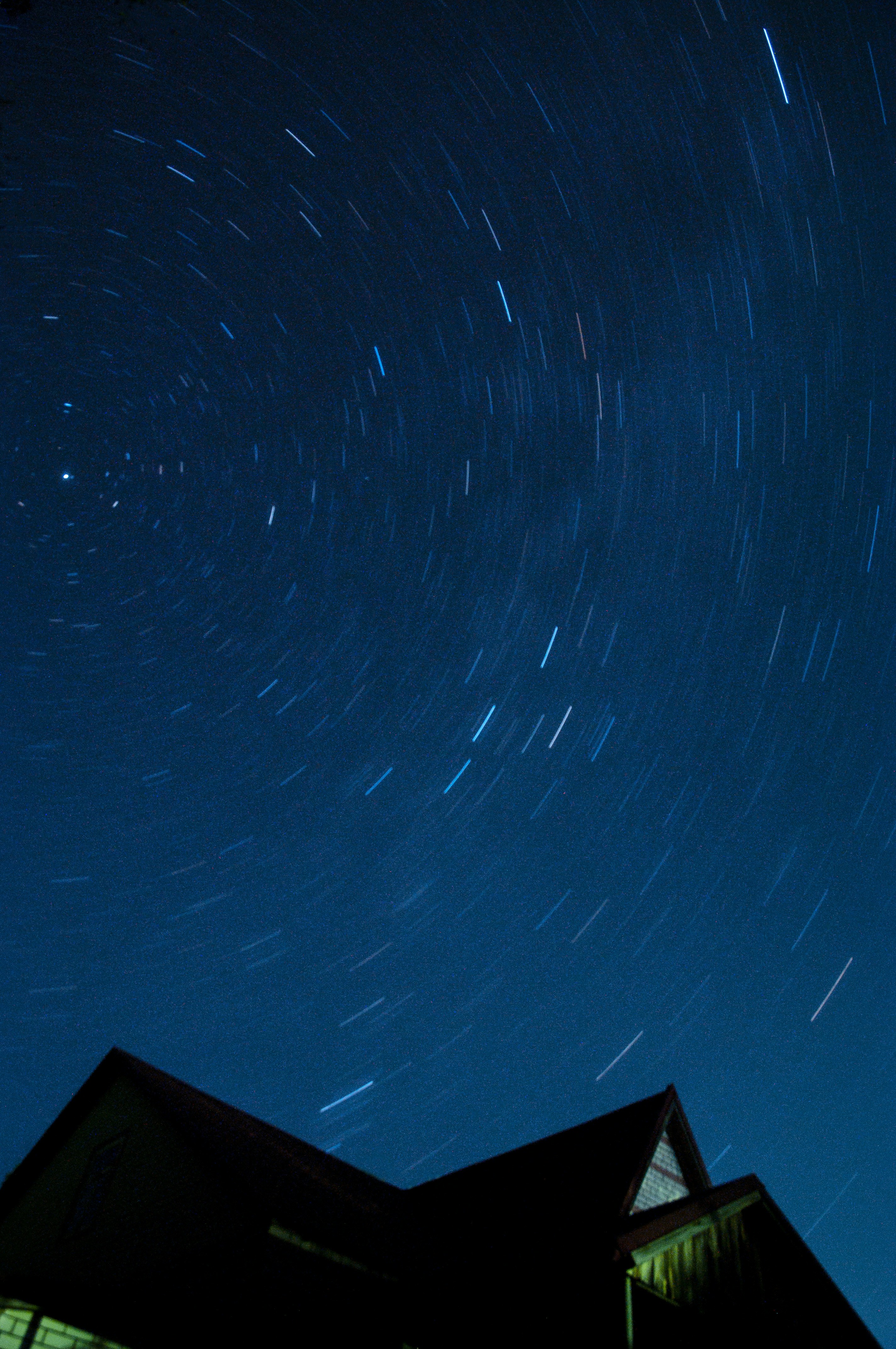 A house with a star trail in the sky