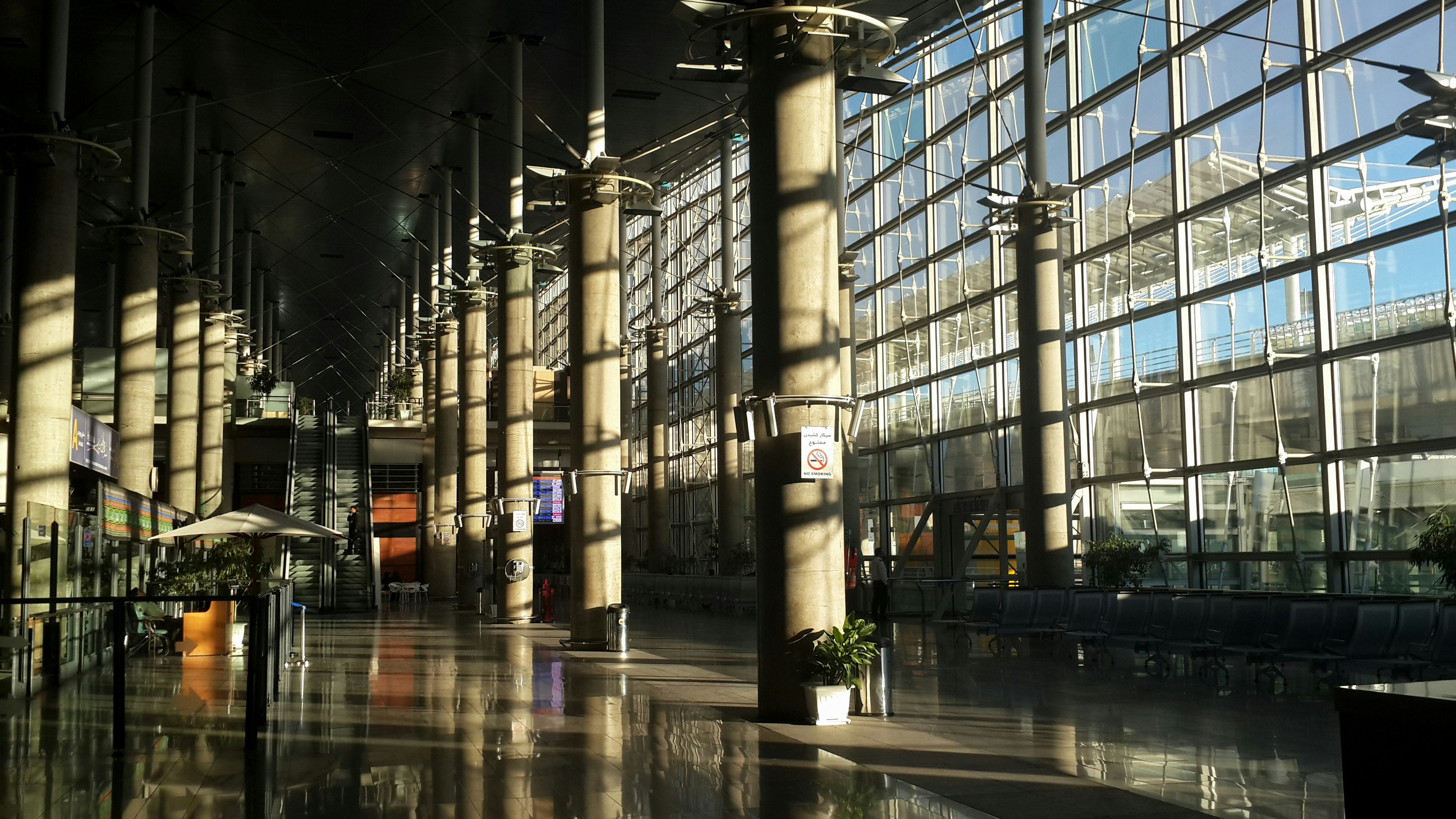 Modern airport terminal with bright natural light streaming through glass windows