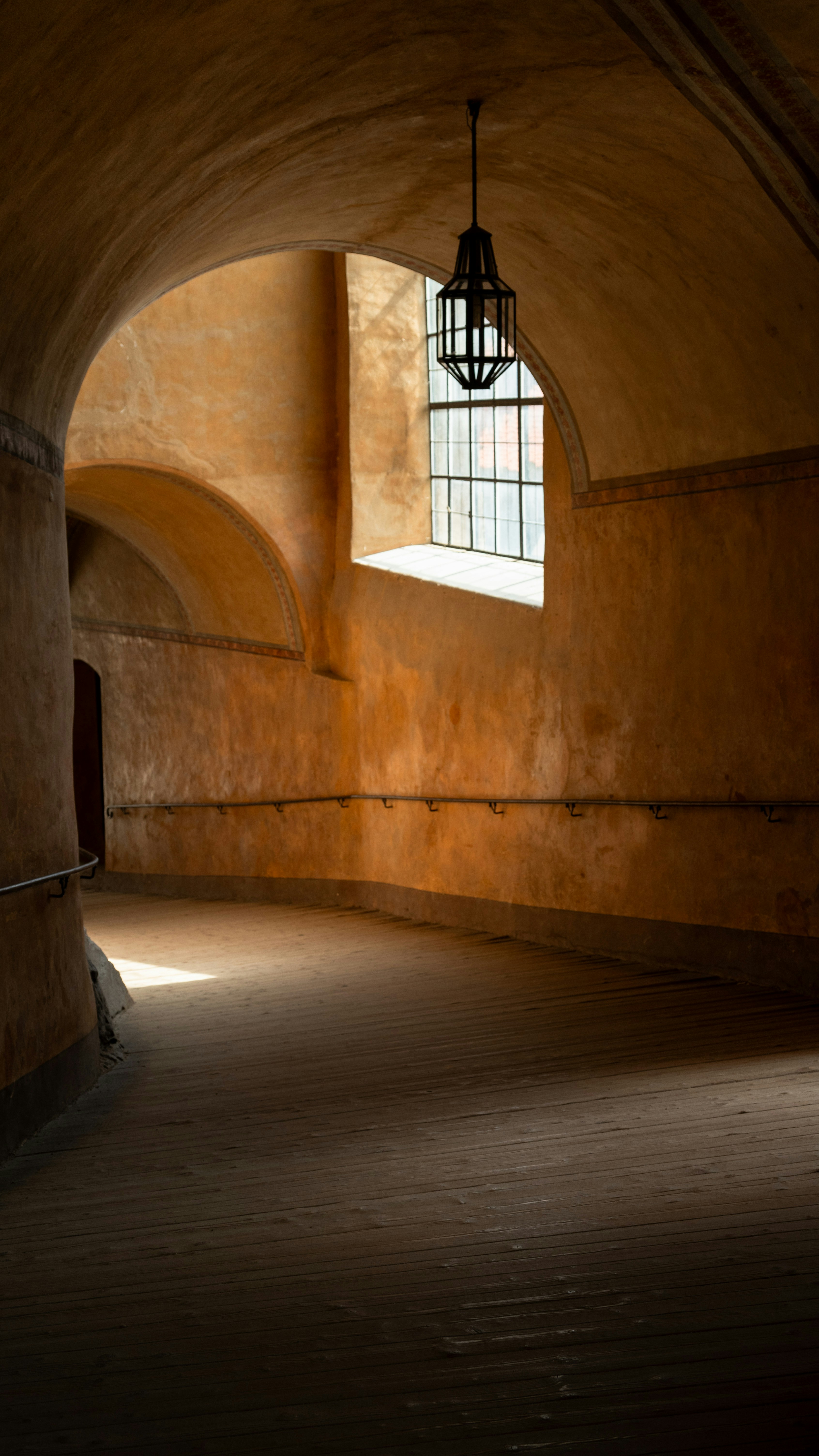 A dimly lit room with a lantern hanging from the ceiling