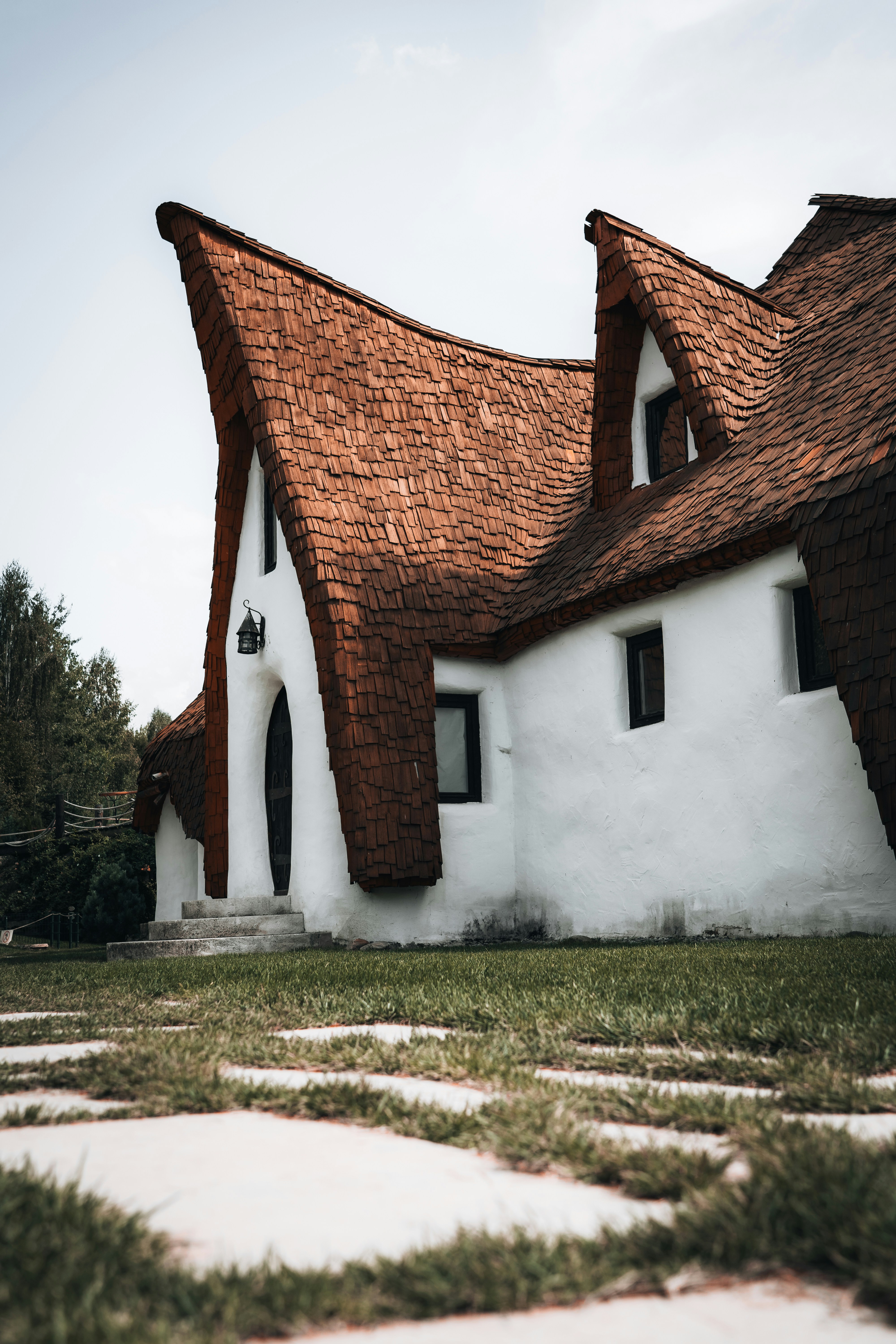 A white house with brown shingles and a brown roof photo – Free ...