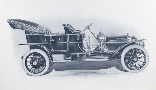 Vintage dark automobile with white-walled tires