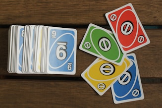 A pile of cards sitting on top of a wooden table