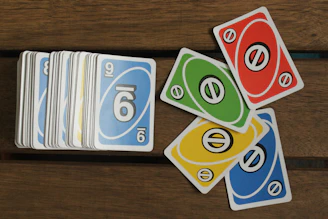 A pile of cards sitting on top of a wooden table