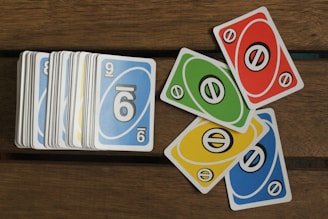 A pile of cards sitting on top of a wooden table
