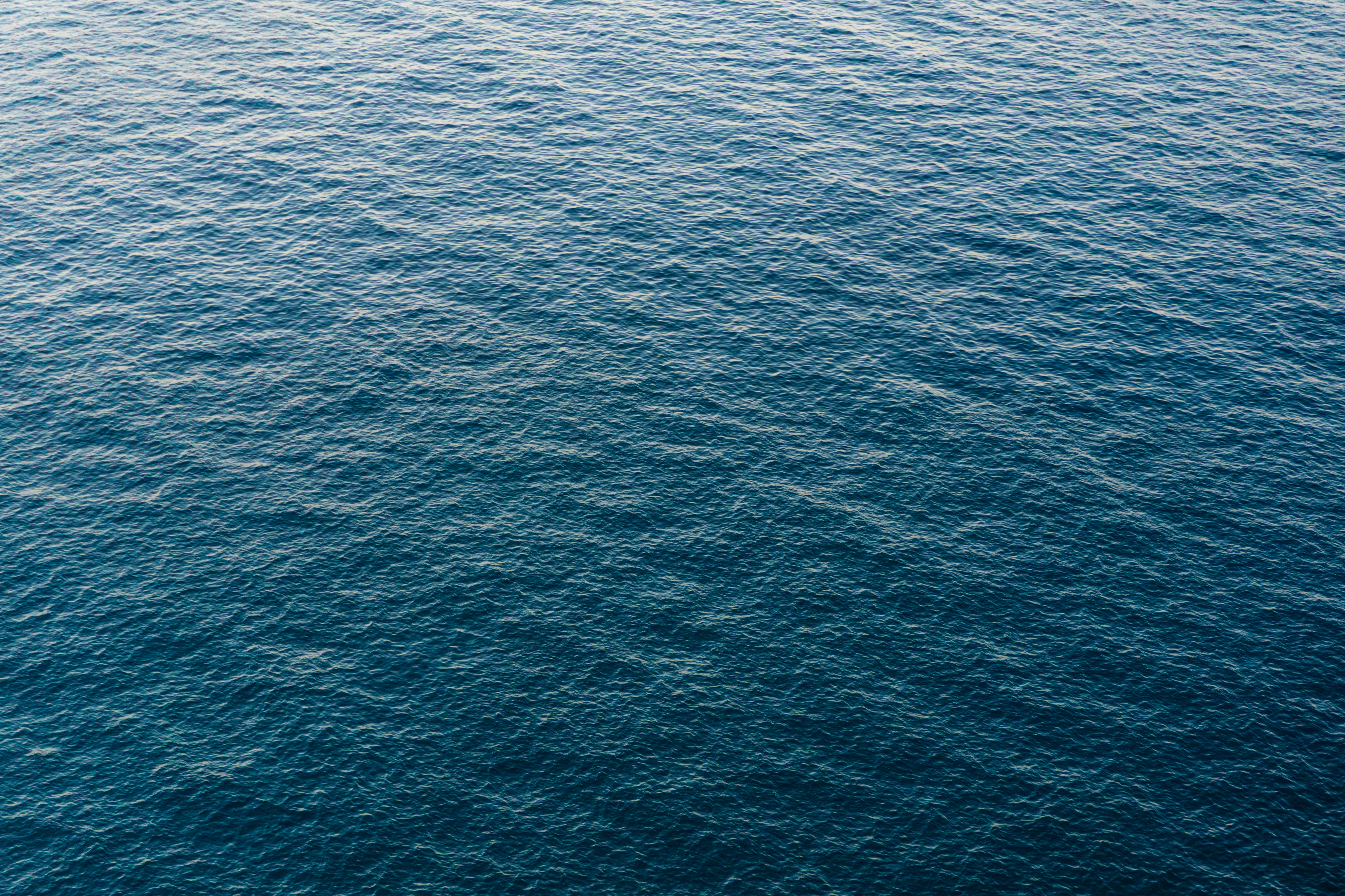 A boat floating on top of a large body of water
