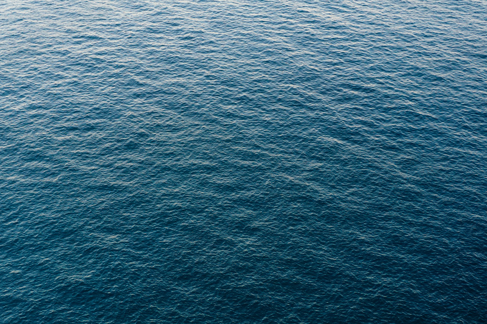 A boat floating on top of a large body of water