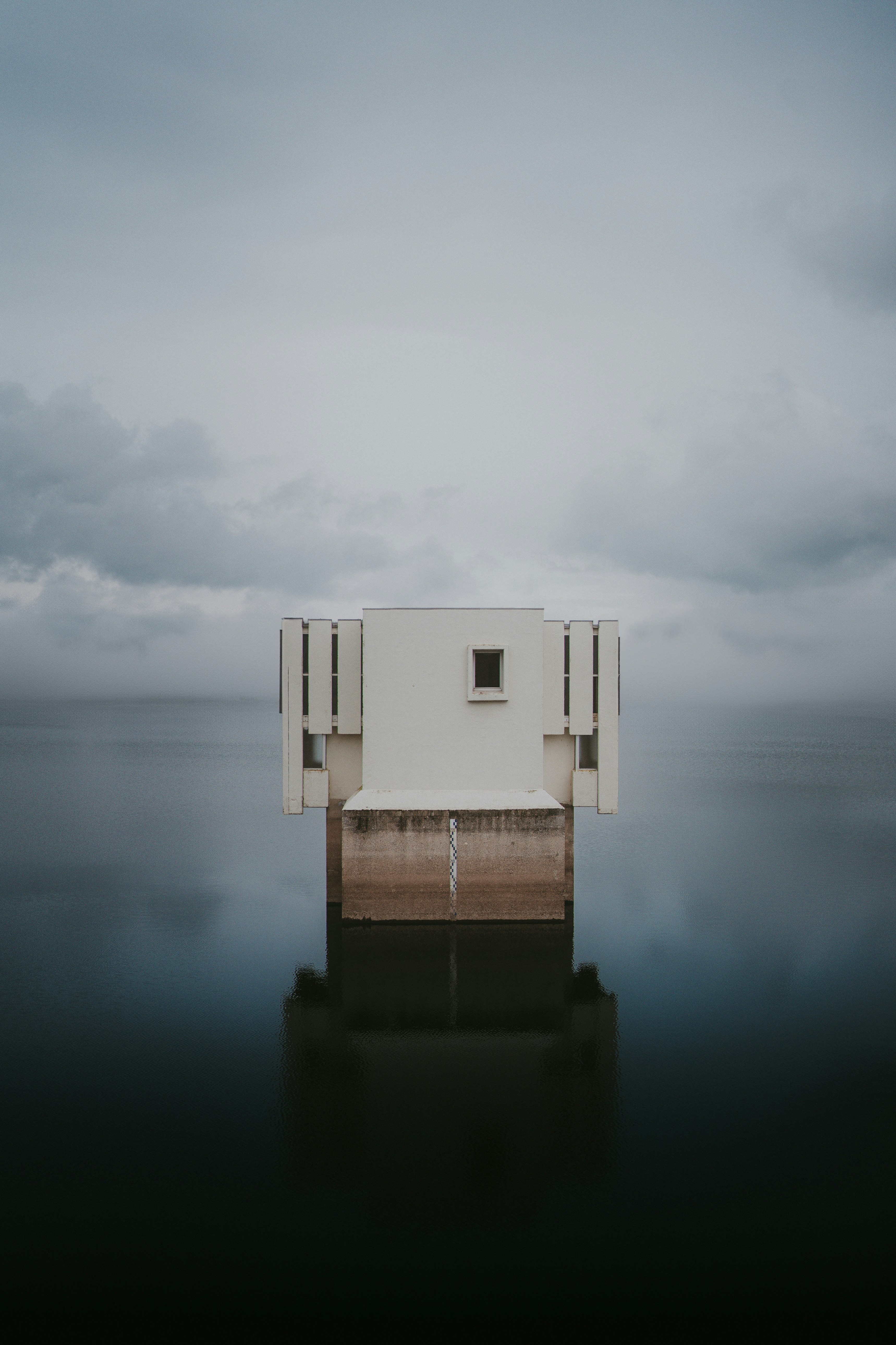 A white building sitting on top of a body of water