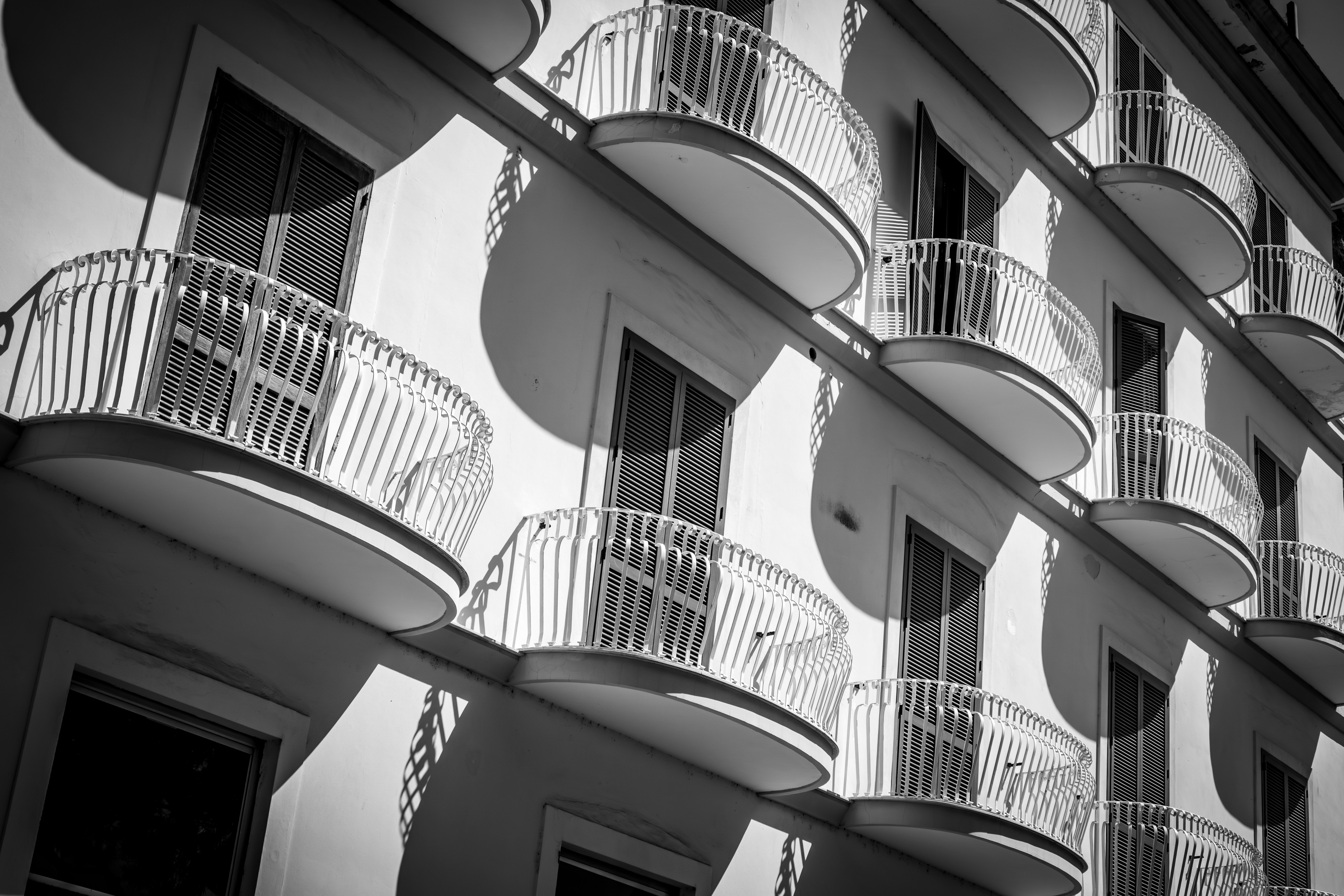 A black and white photo of a building with balconies
