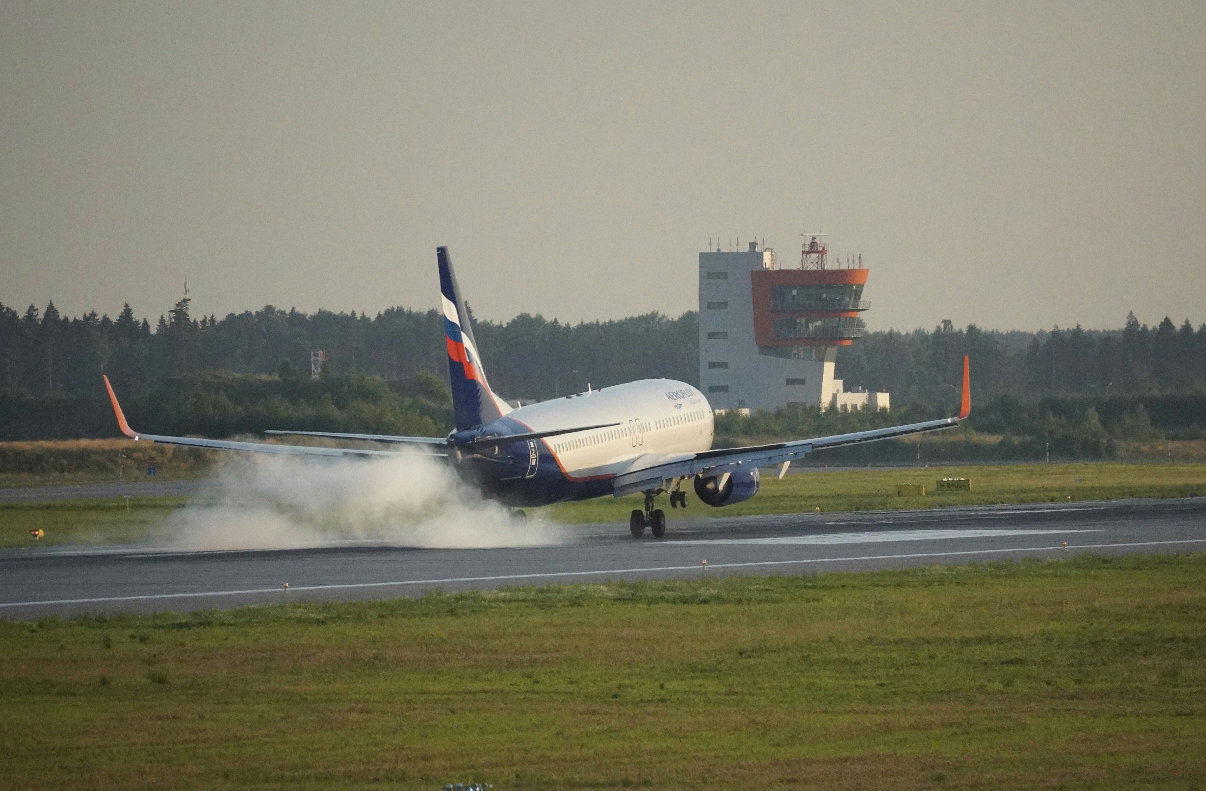 Aeroflot Airbus A321 parked at a terminal gate at Istanbul Airport, surrounded by ground crew and vehicles