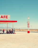 A gas station with a car parked in front of it