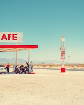 A gas station with a car parked in front of it