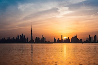 The sun is setting over the city skyline