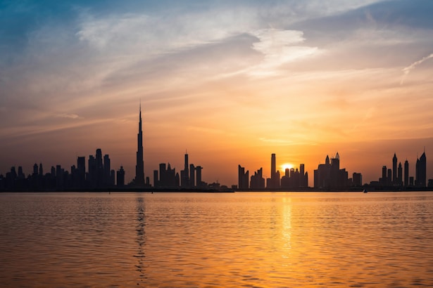 The sun is setting over the city skyline