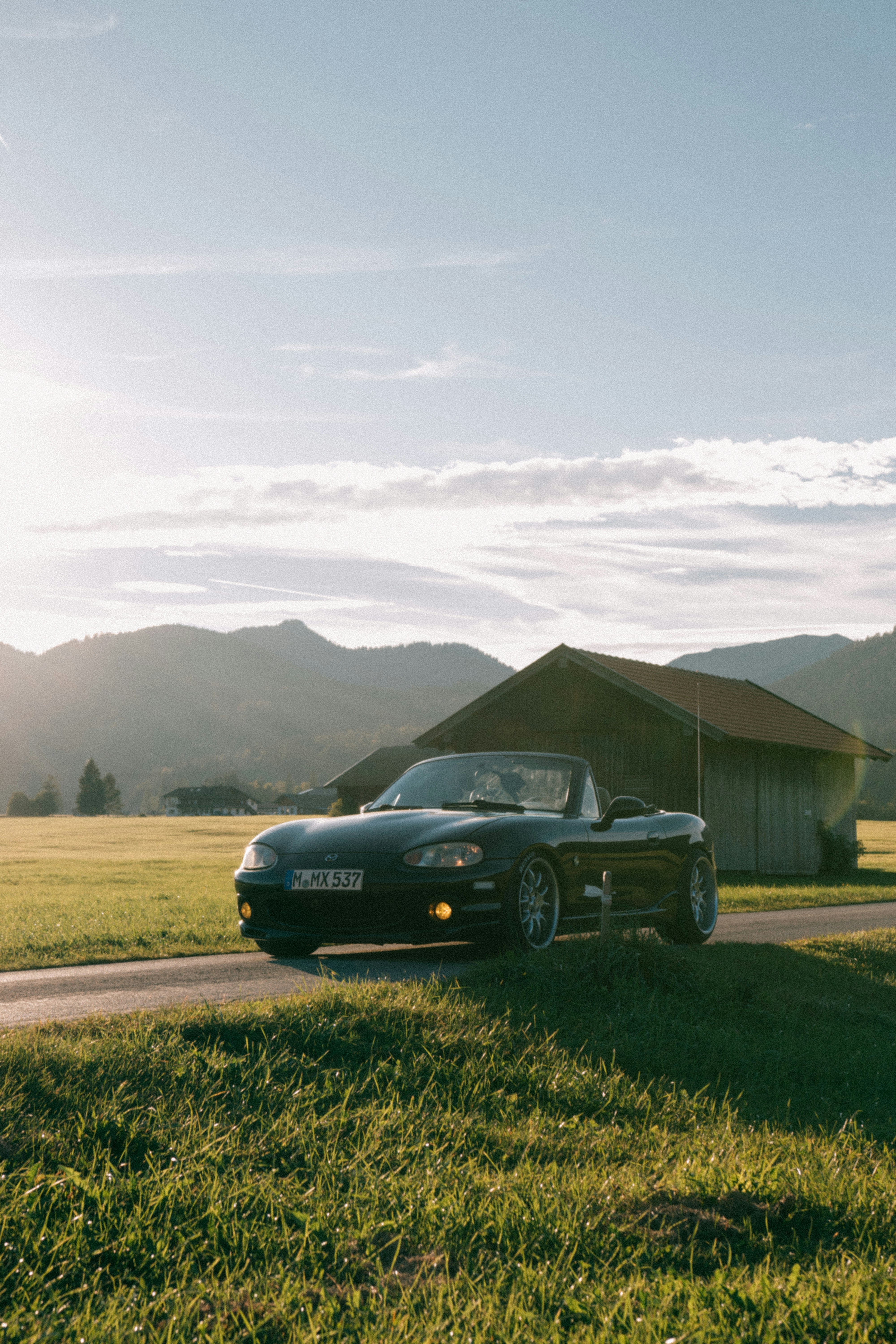 A black sports car parked on the side of a road