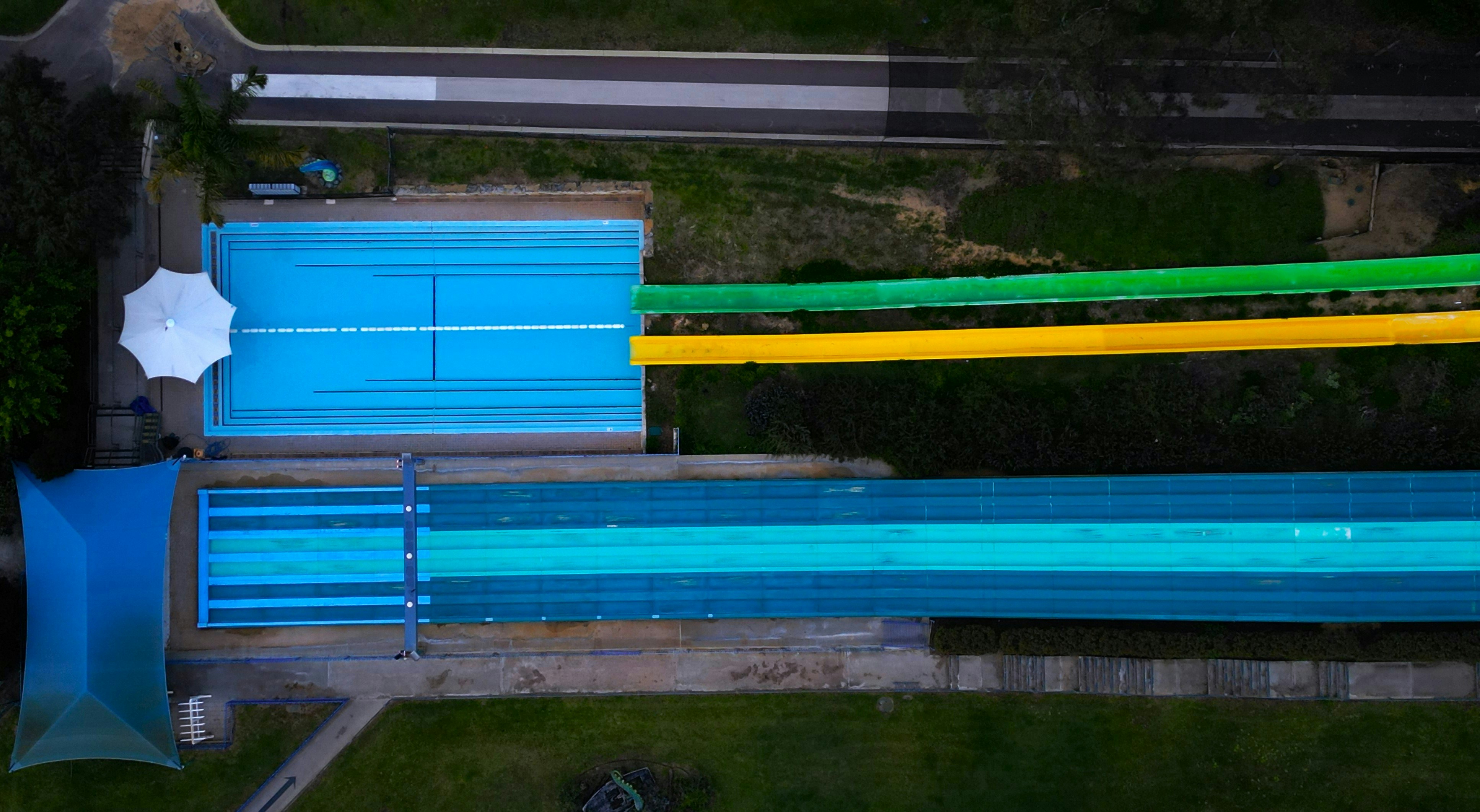 An aerial view of a swimming pool and water slide