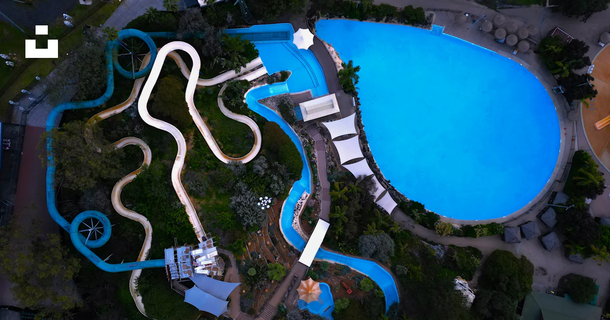 An aerial view of a swimming pool with a slide photo – Free Aerial view ...