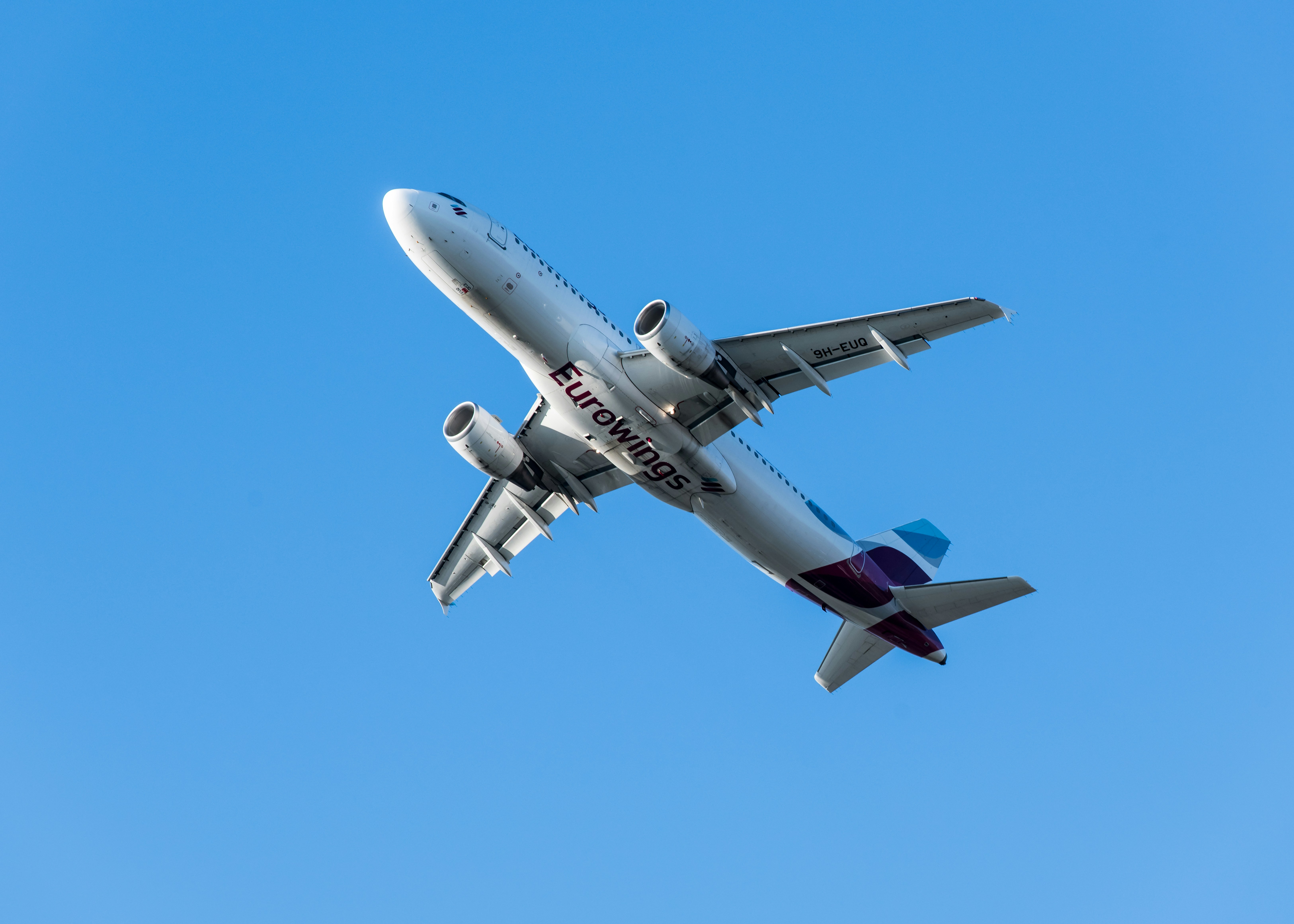 A large jetliner flying through a blue sky, 