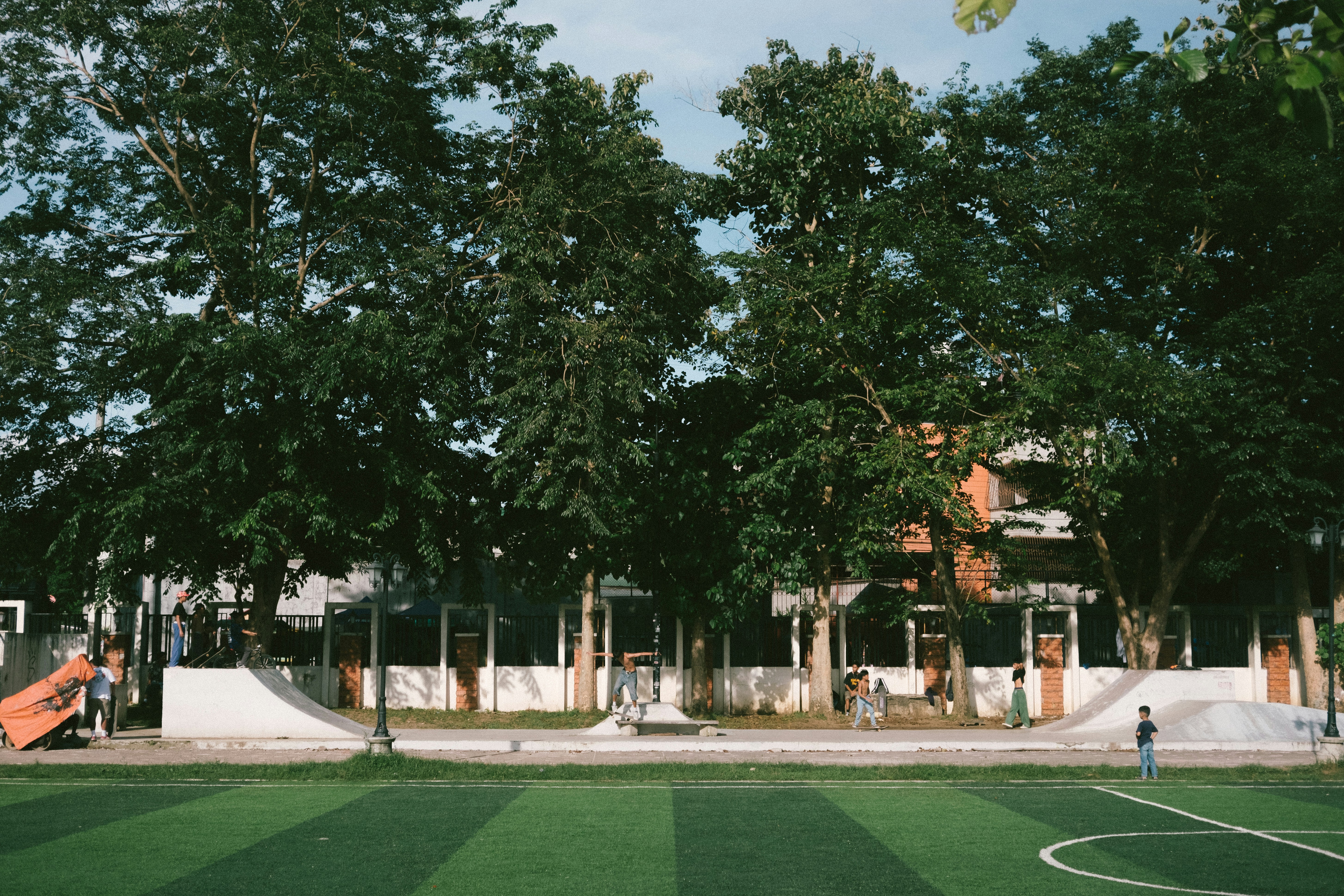 A soccer field in front of a large building