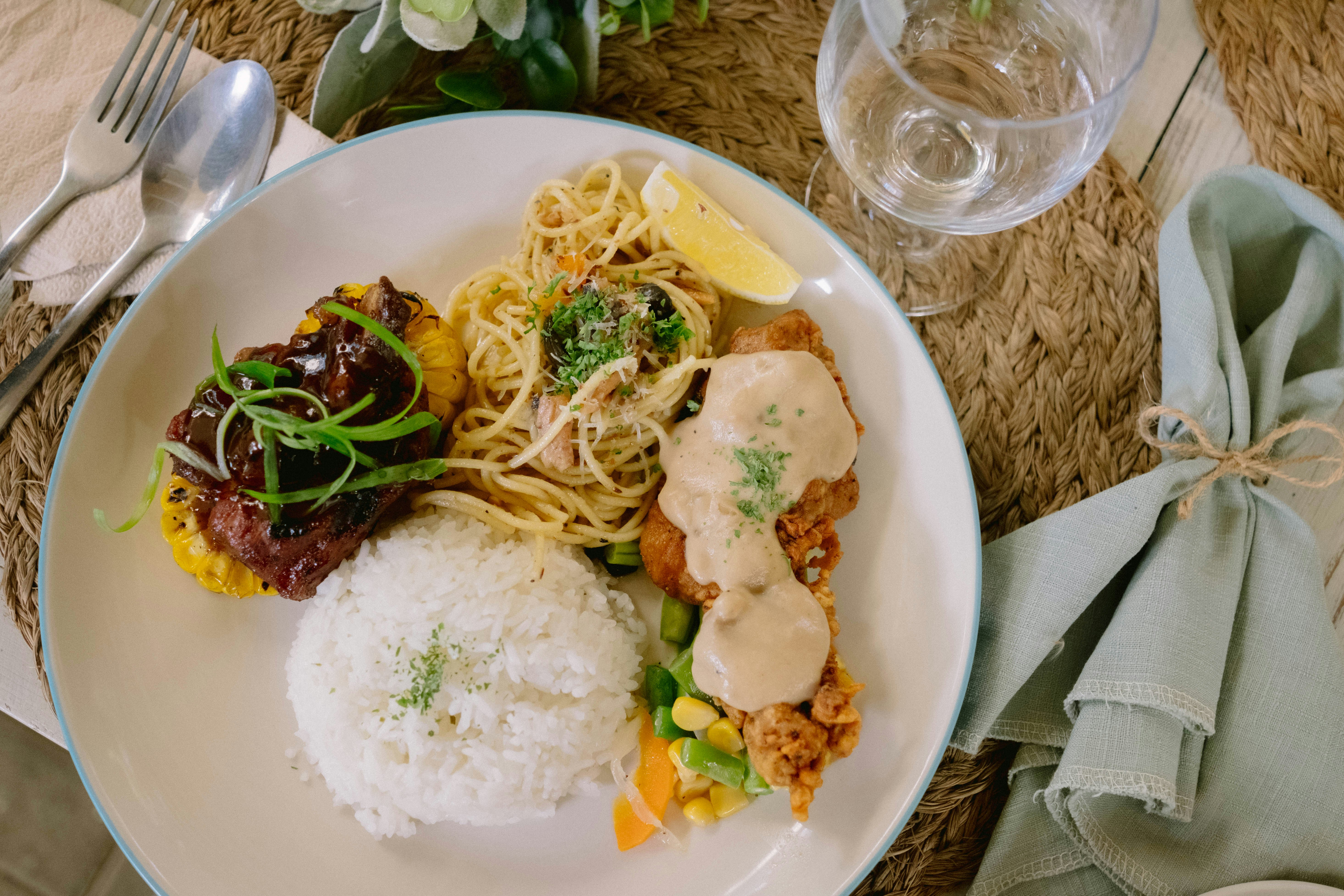 A plate of food on a table with silverware