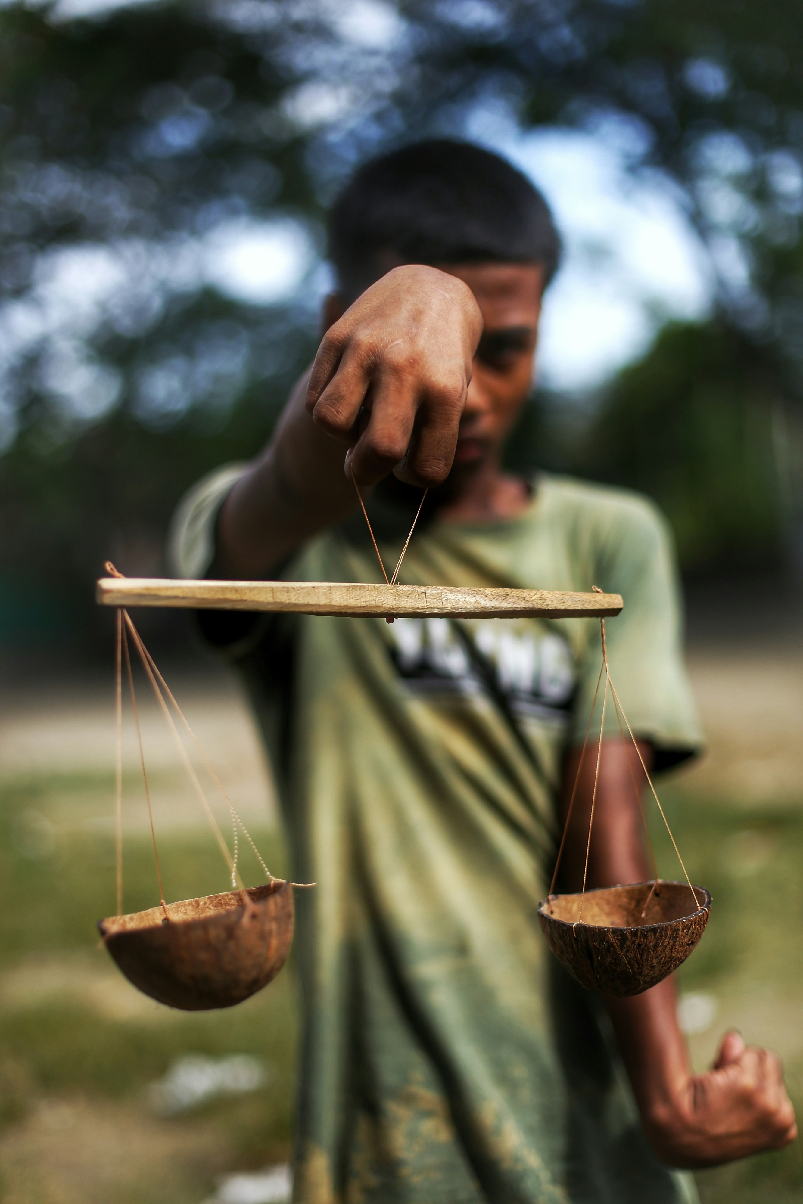A man holding a balance scale with two hands
