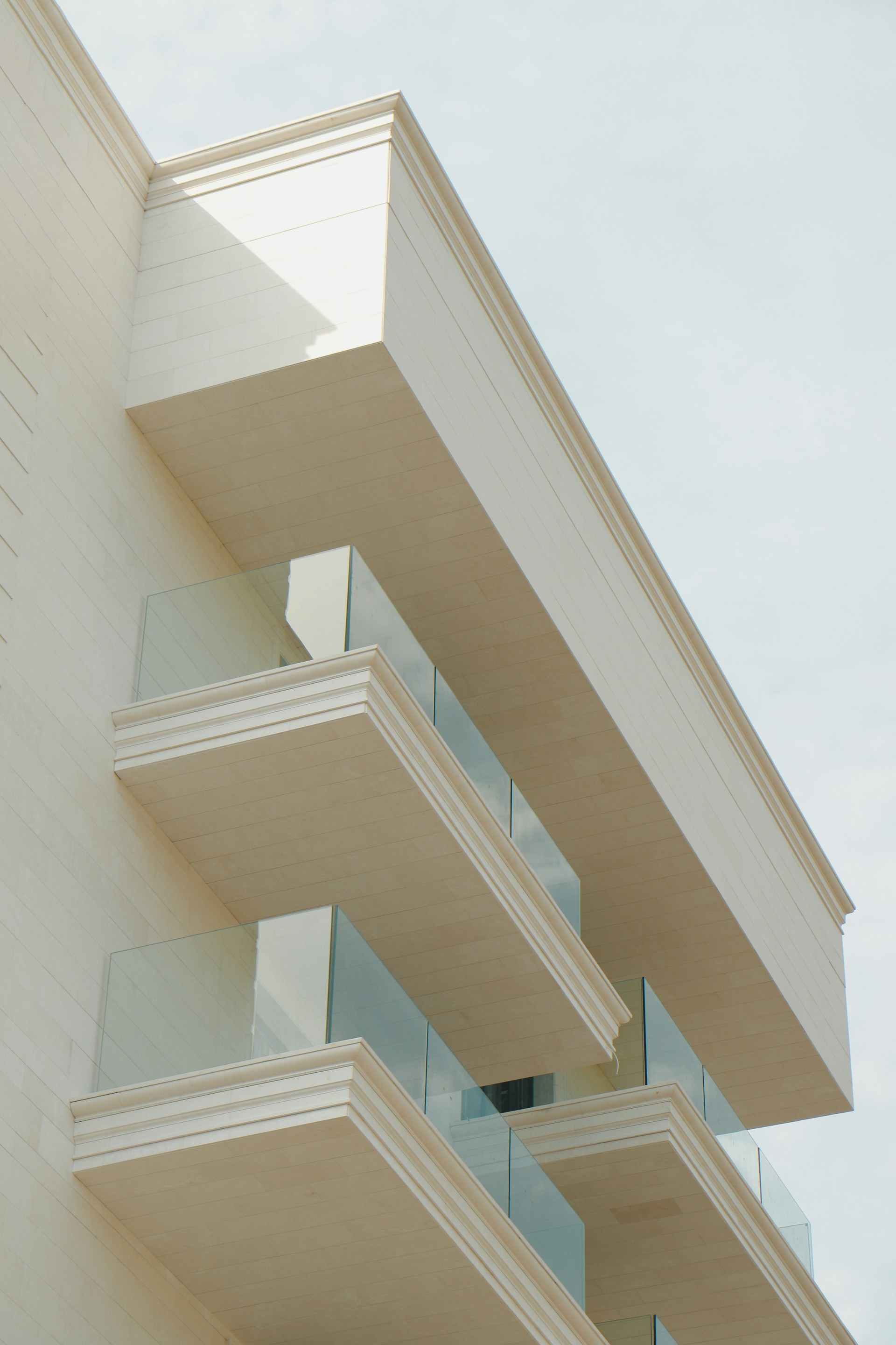 A tall white building with balconies and balconies