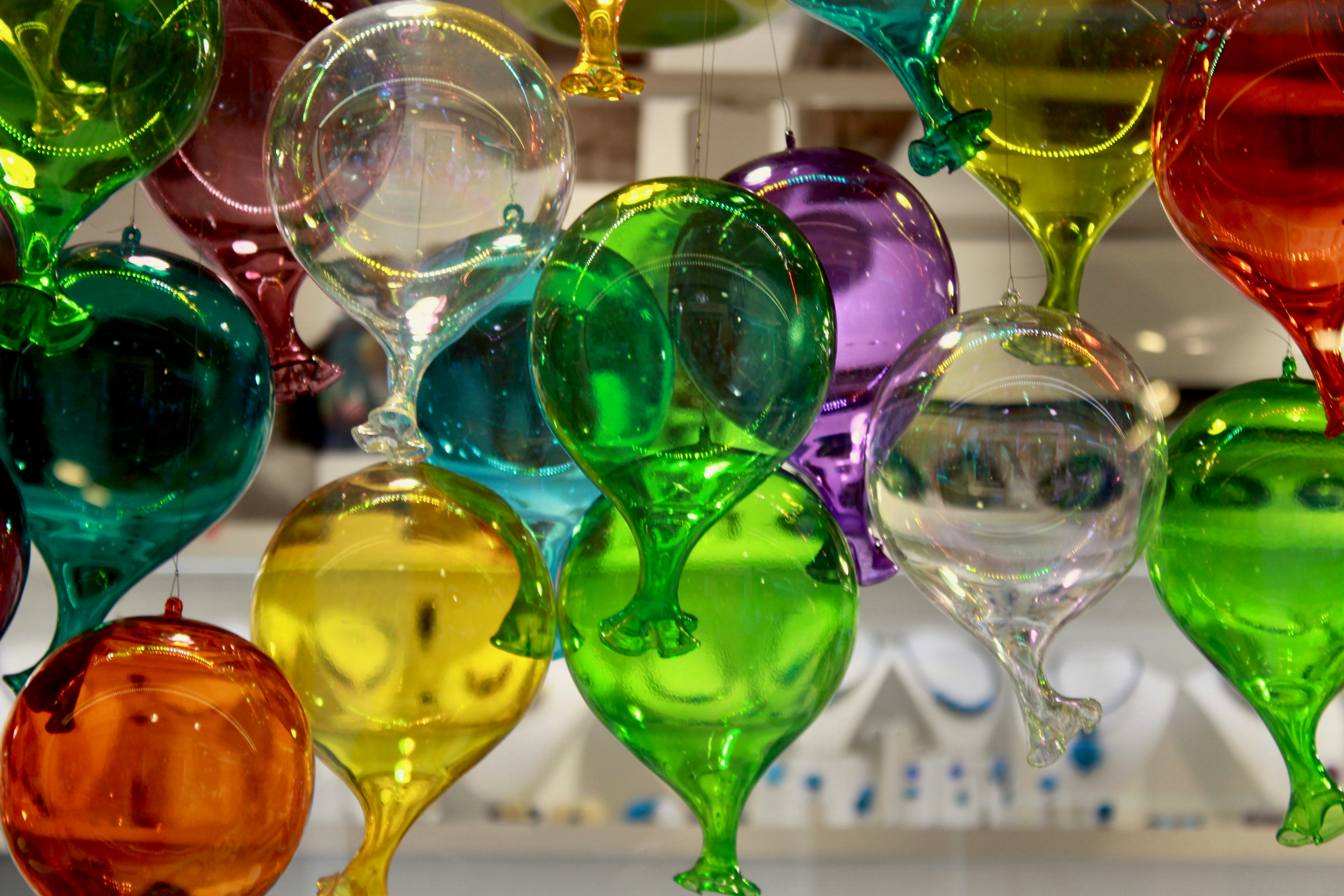 A group of colorful wine glasses sitting on top of a counter