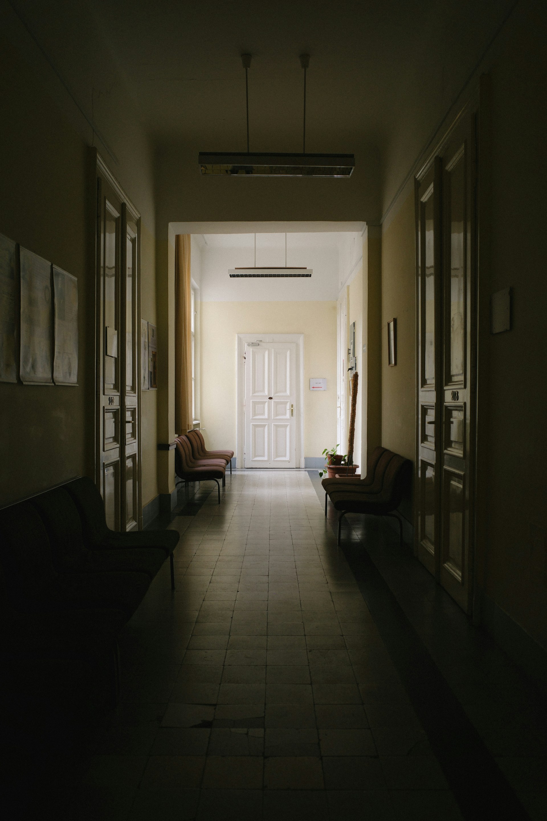 A dimly lit hallway leading to a door