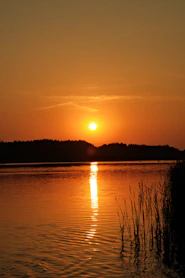 The sun is setting over a body of water