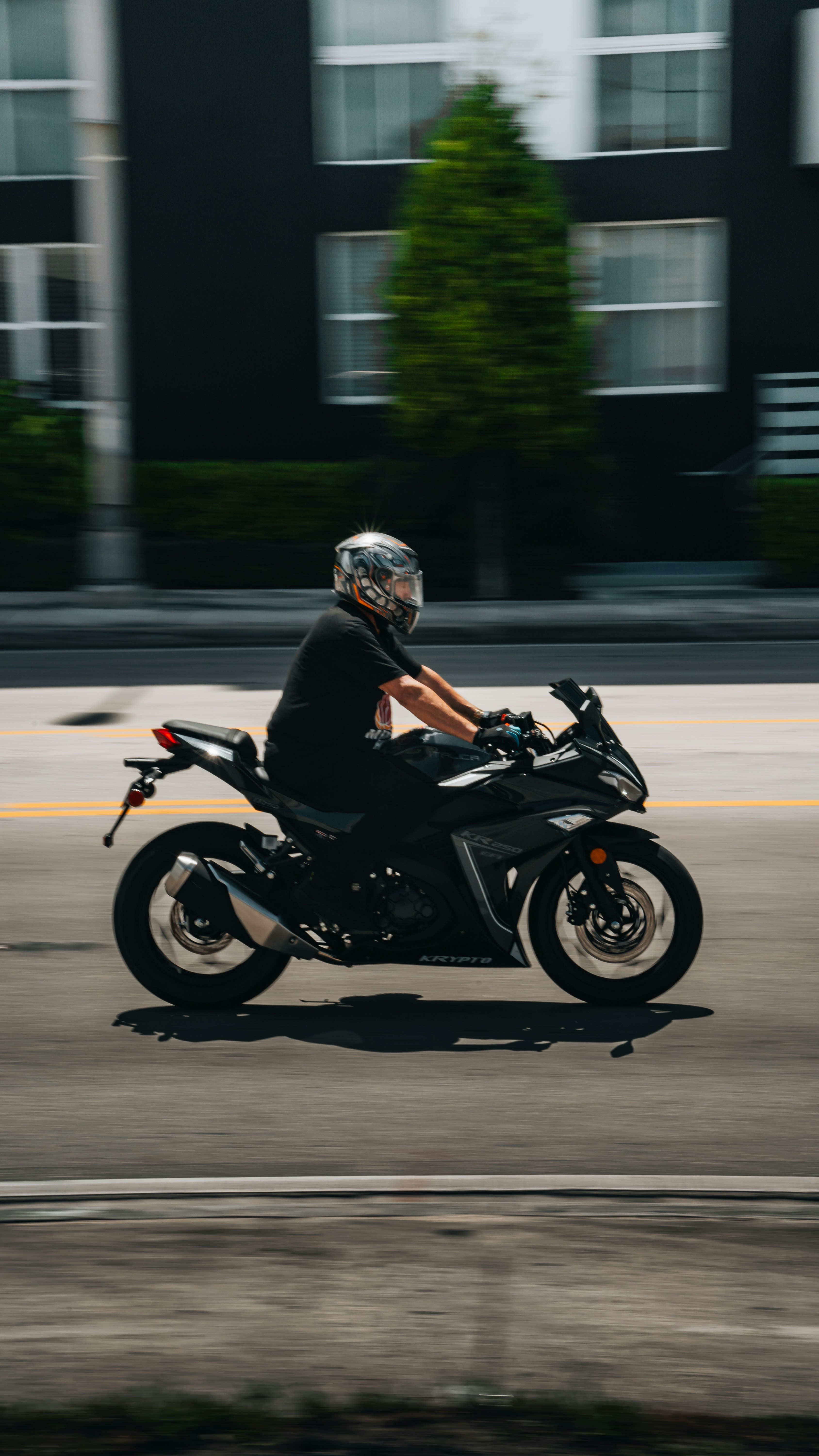 A man riding a motorcycle down a street