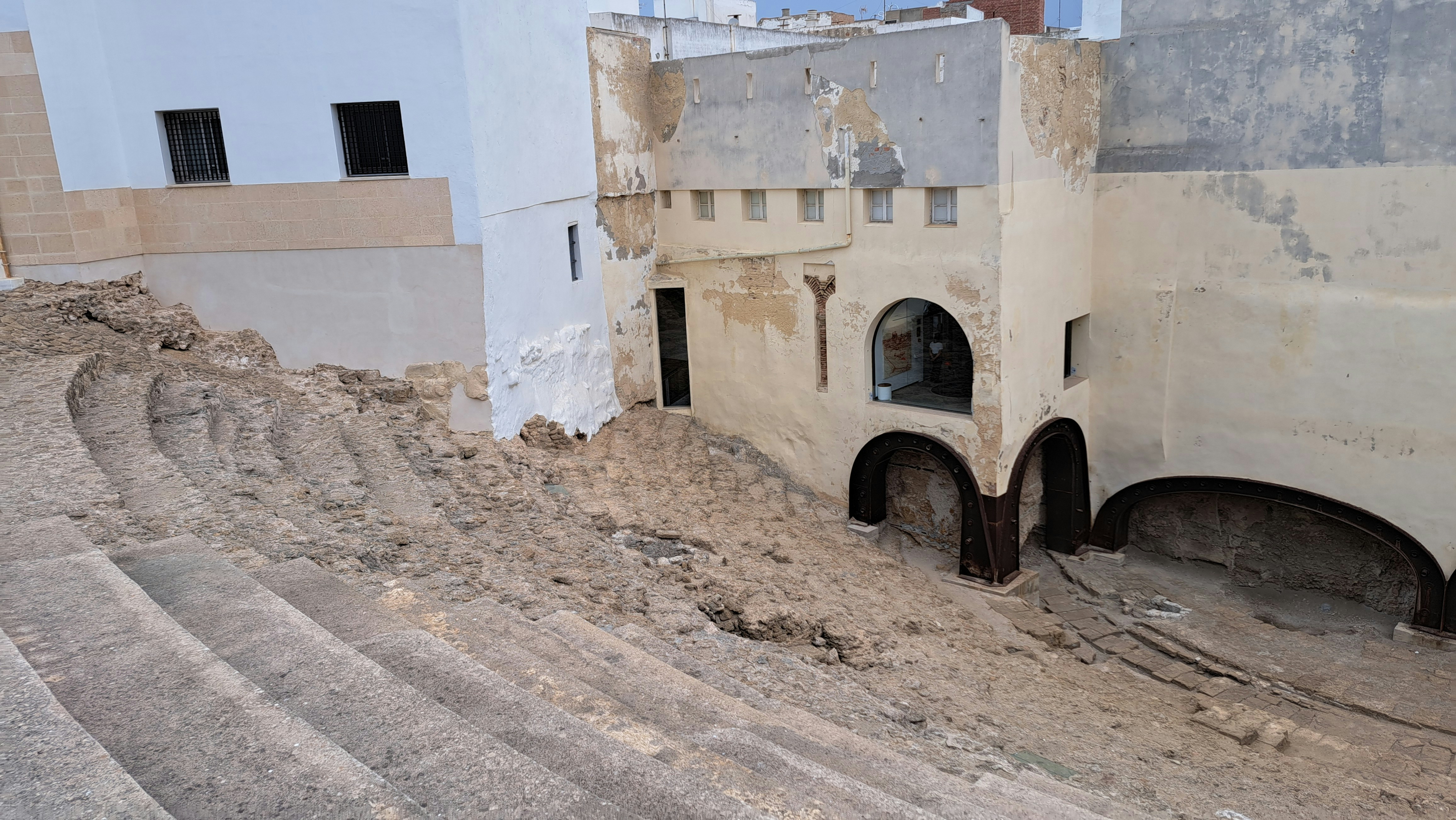 An old building with a lot of dirt on the ground