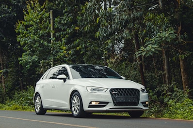 A white car parked on the side of the road
