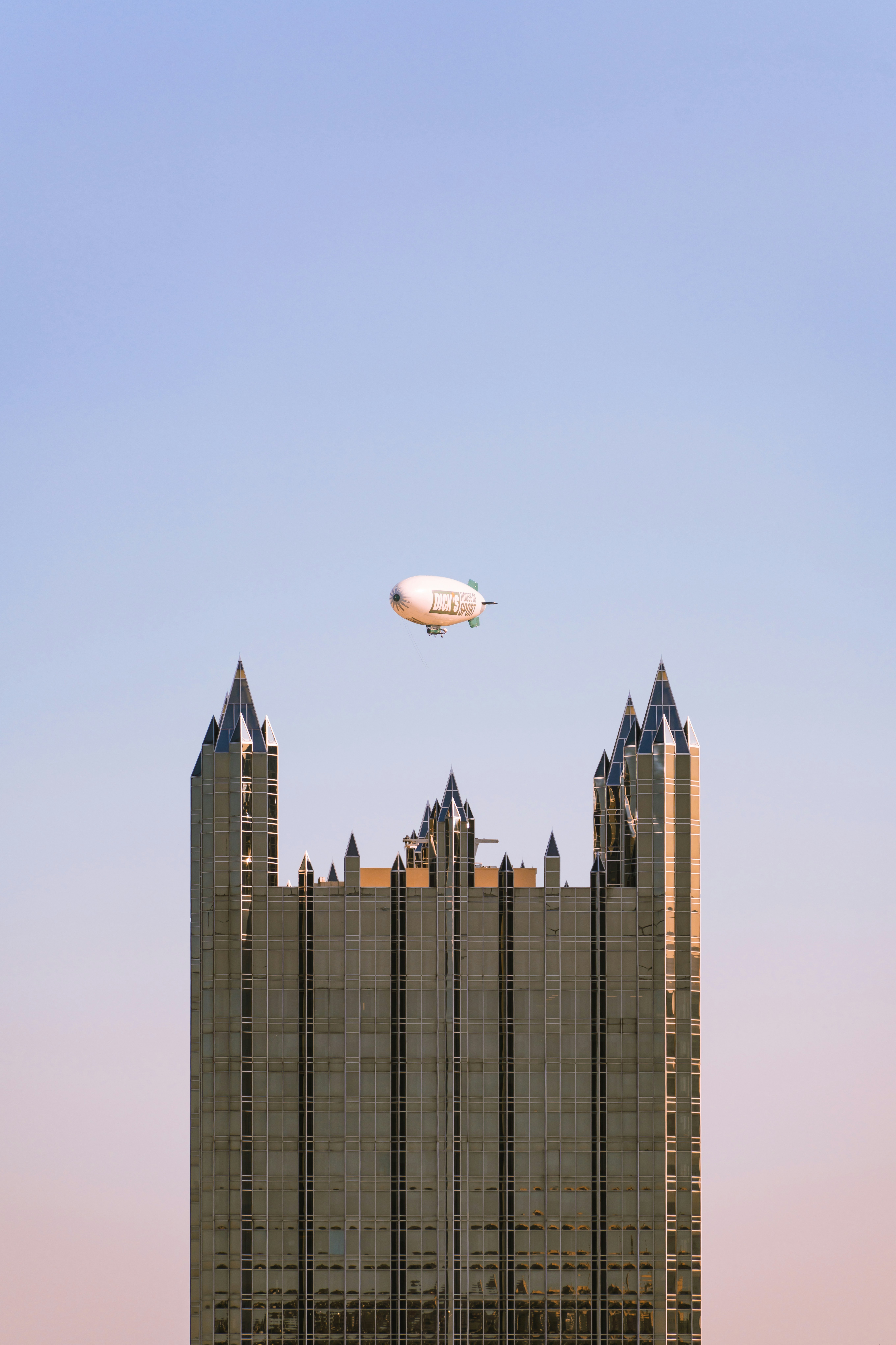 Ein großer Ballon, der über ein hohes Gebäude fliegt