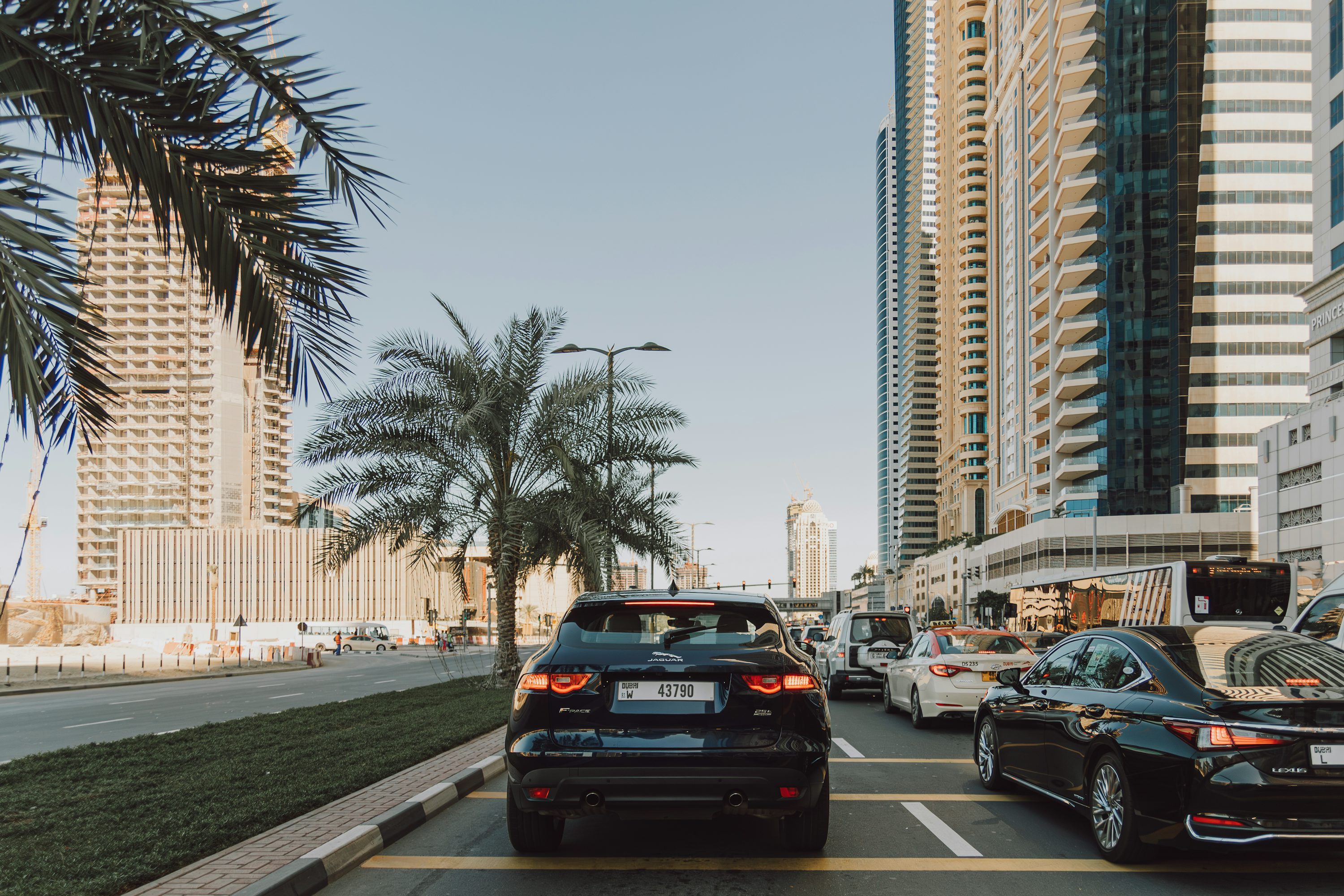 A street filled with lots of traffic next to tall buildings