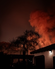 A large plume of smoke billowing out of a building