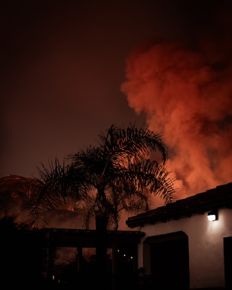 A large plume of smoke billowing out of a building