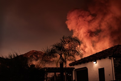 A large plume of smoke billowing out of a building