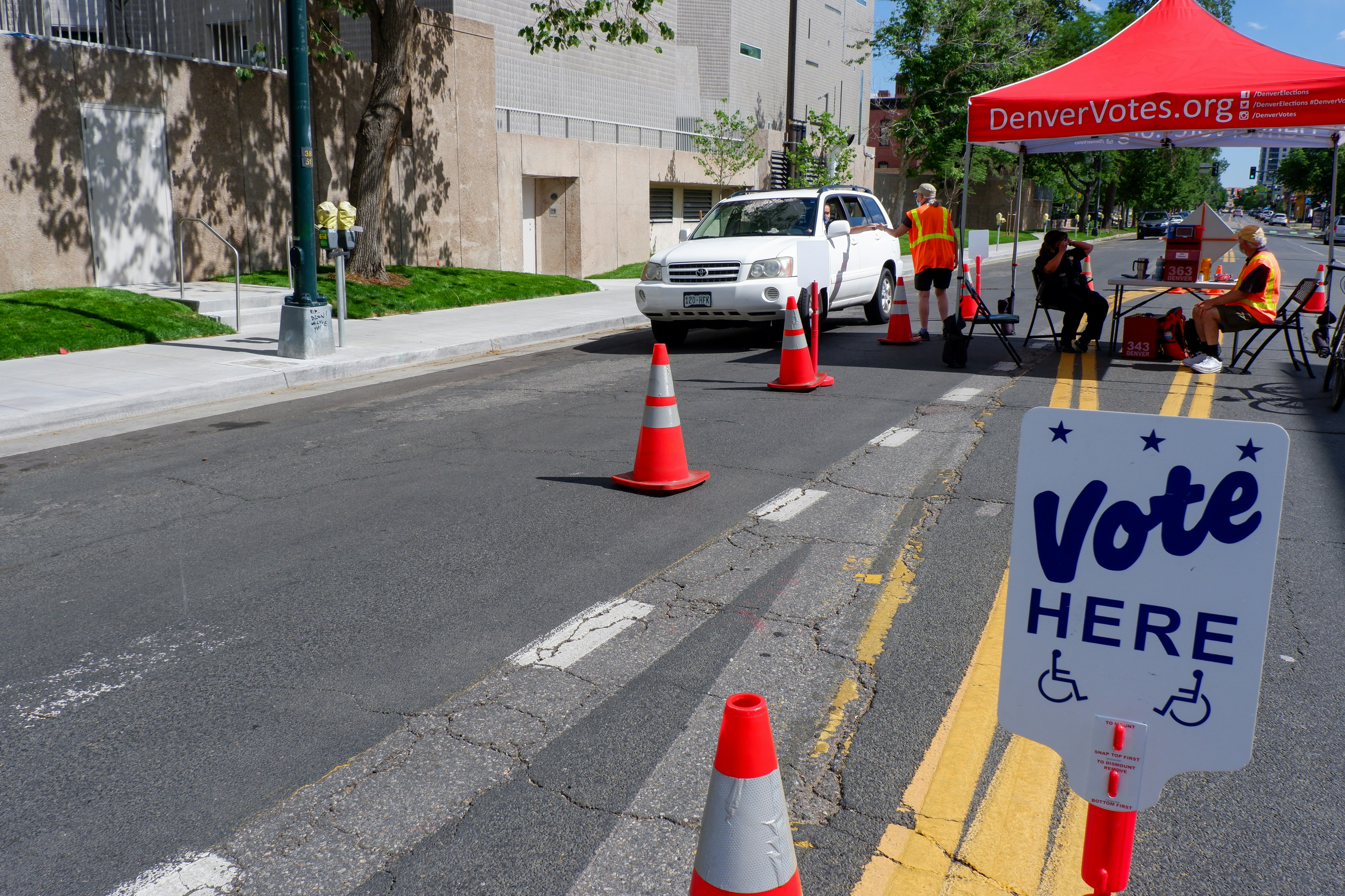 A vote here sign in the middle of a street