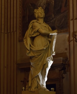 A statue of a woman holding a piece of paper