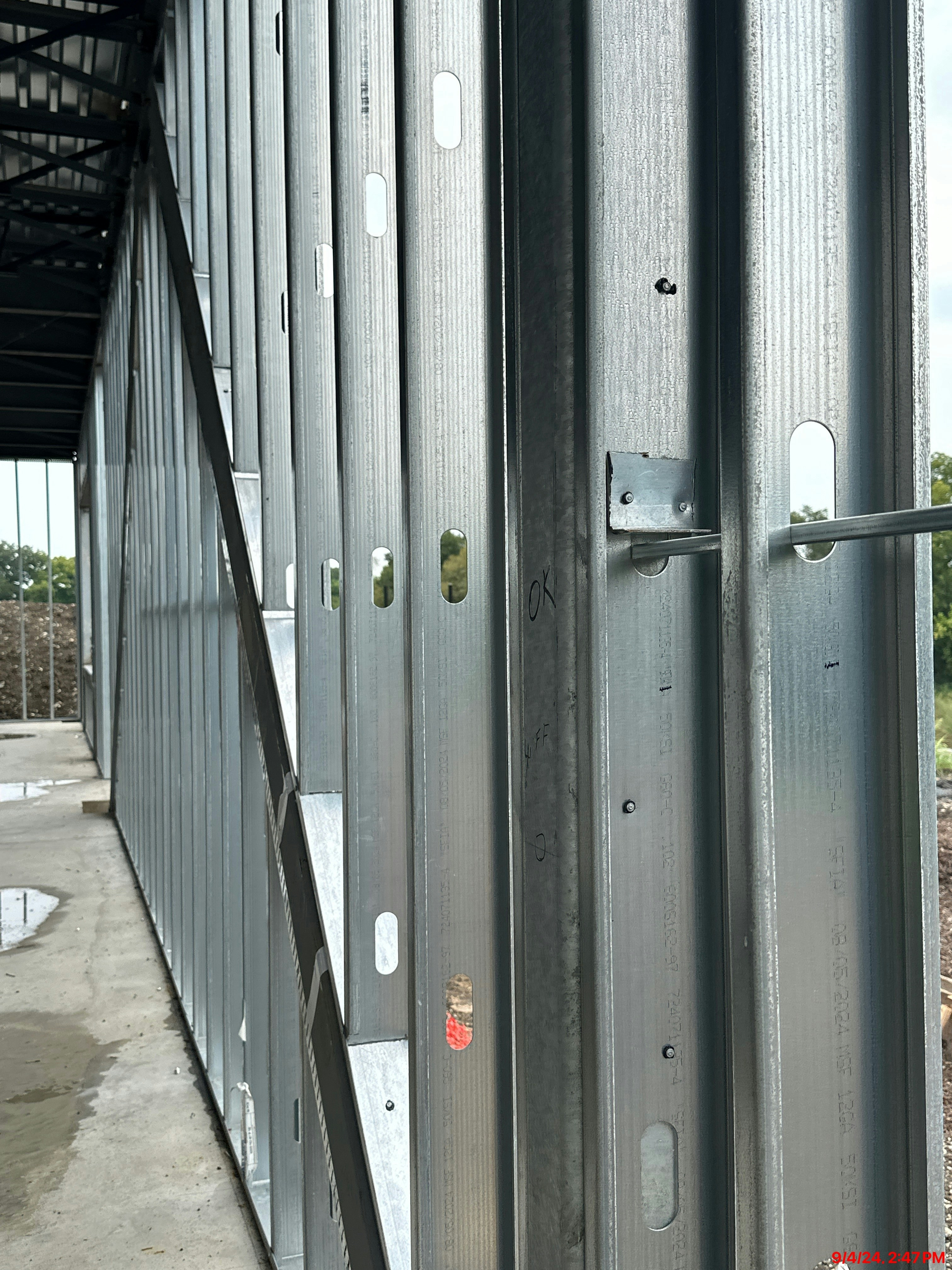 Metal stud framing in a commercial building interior with silver steel studs and track systems
