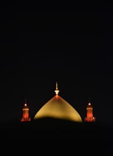A view of a building at night from across the water