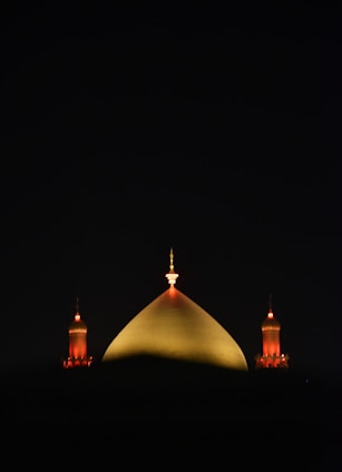 A view of a building at night from across the water