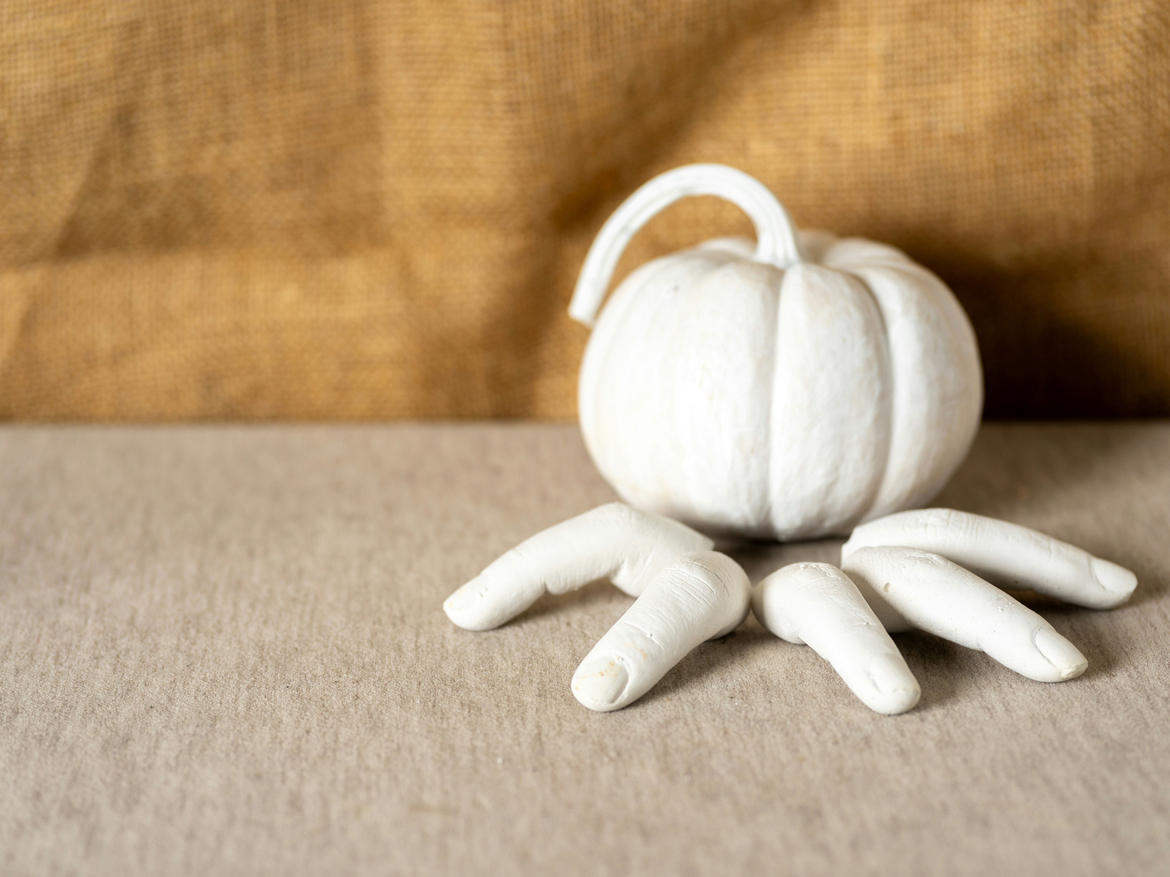 A small white pumpkin sitting on top of a couch
